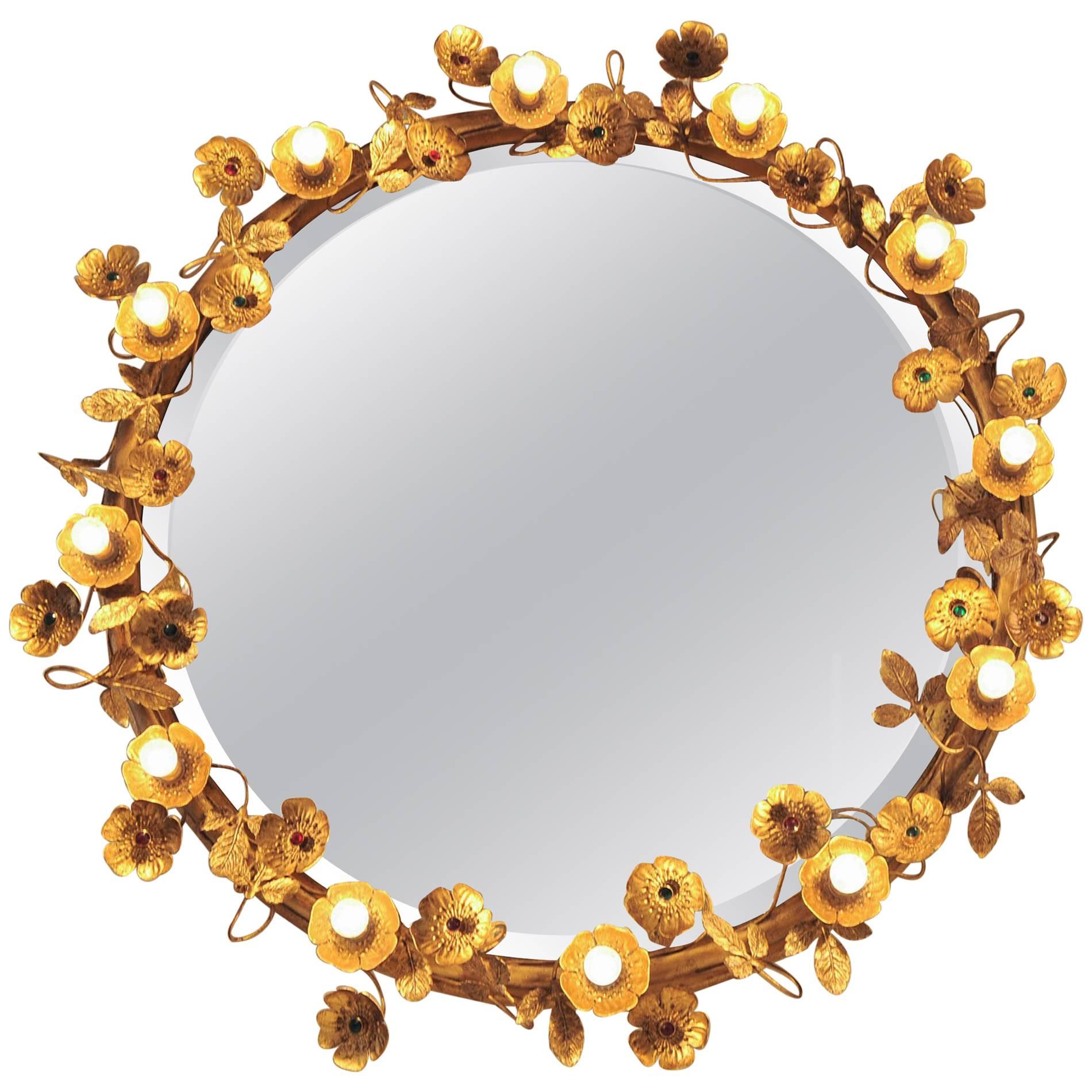 Super glamorous contemporary wall mirror from the VW collection that comprises of delicate gold brass flowers and leaves that encircle the beveled mirror. Each flower is finished with a ruby or emerald centre unless it holds one of the small