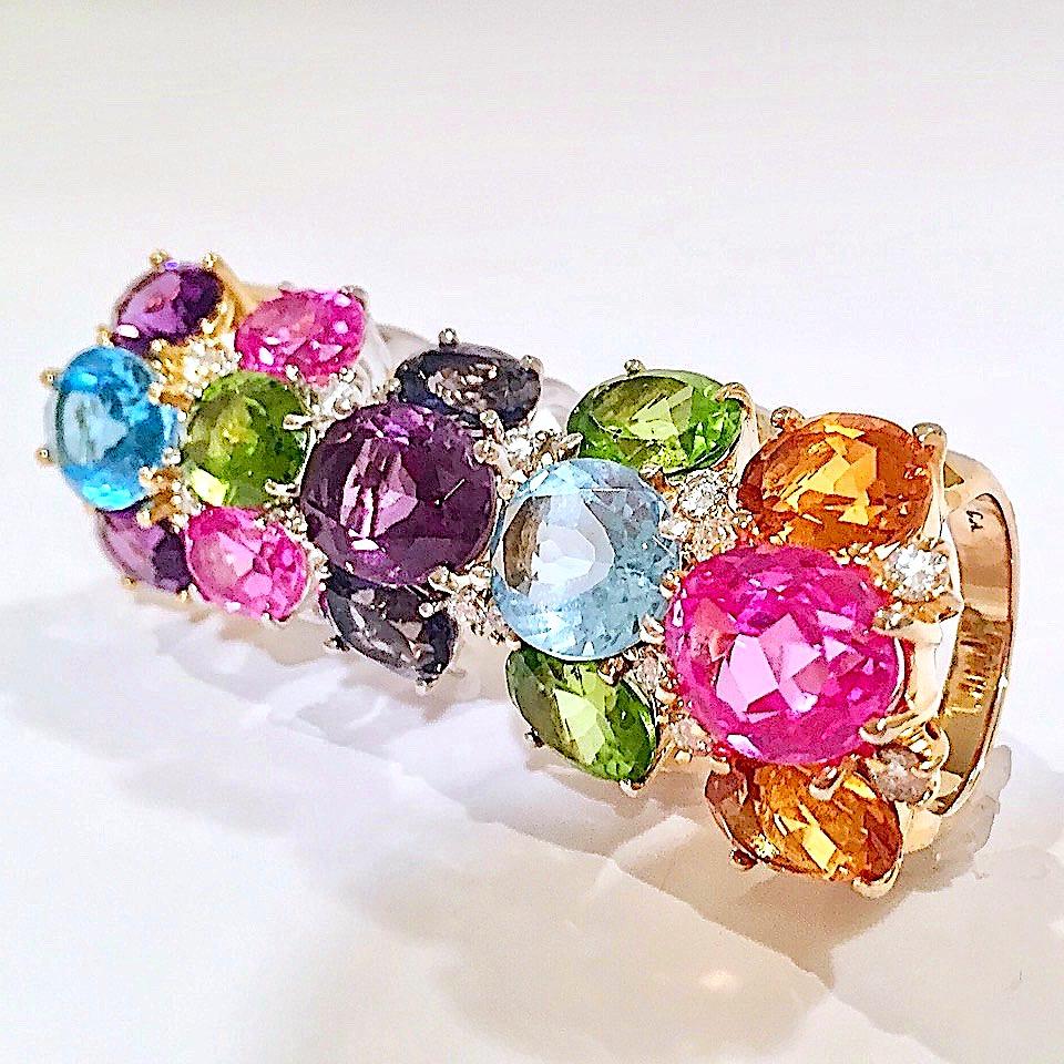 18kt Medium GUM DROP™ Ring with Pink Topaz (approx 5cts) and two Peridot (approx 7 cts) and Diamonds approx 0.35cts
The ring can be sized or ordered to your ring size.

The GUM DROP™ Earring and Ring collection are made to order and customized for