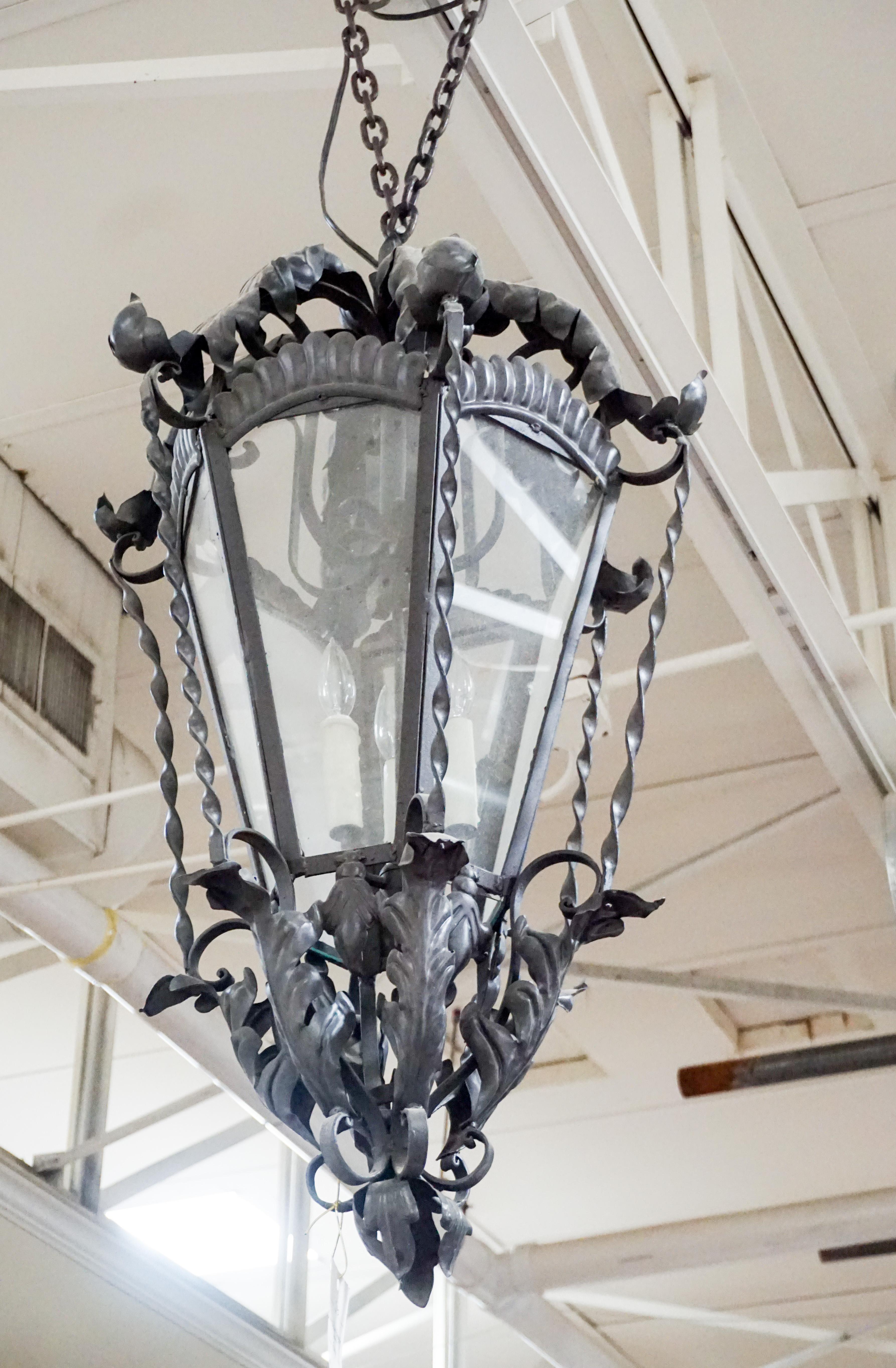 Medium hanging iron lantern, wired and ready for installation. 

Origin: France

Measurements: 24