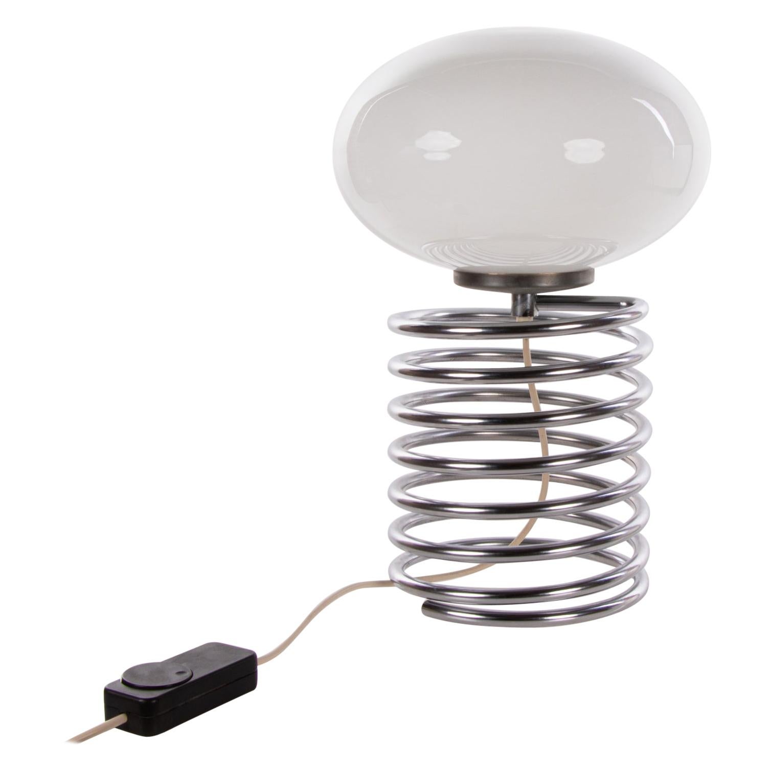 Medium sized design desk light with a white glass shade on a chromed spiral steel base. Designed 1965 by Ingo Maurer for Design M, Germany. 

Design: Ingo Maurer. 
Model: Spirale, Spiral. 
Manufacturer: Design M. 
Measures: height 18