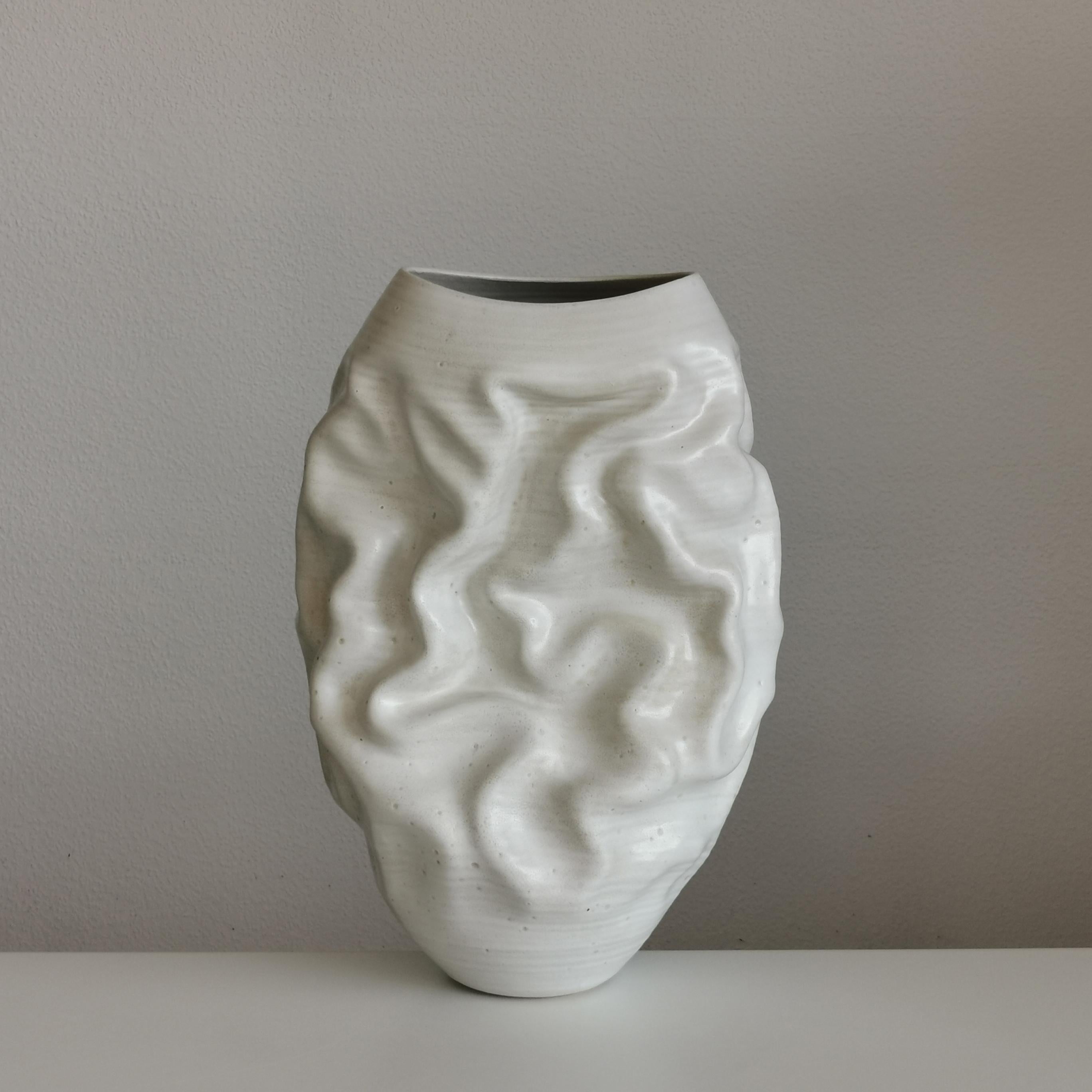 Vessel No. 126 white dehydrated form vessel from ceramic artist Nicholas Arroyave-Portela.

White St.Thomas clay, stoneware glazes, multi fired to cone 6 (1223 degrees) Made in 2023

45 cm tall, 28 cm wide, 20 cm deep

(Vessel, Interior sculpture,