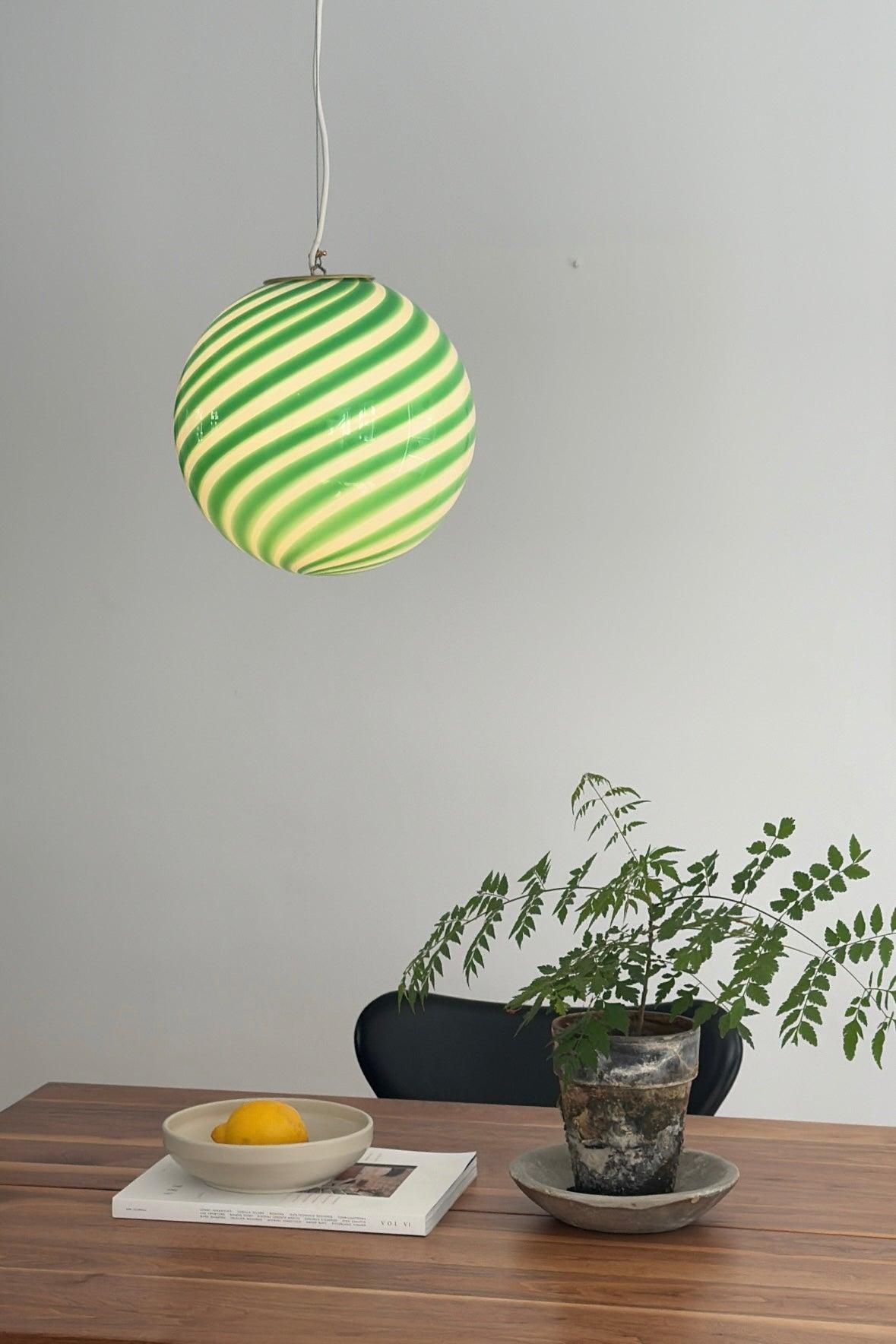 Medium Murano Vintage Candy pendant ceiling lamp in green / white glass. Mouth-blown glass in round shape with swirl pattern. E27 socket. Comes with adjustable suspension. 
Handmade in Italy.
D:30 cm  

As it is mouth blown glass, the expression