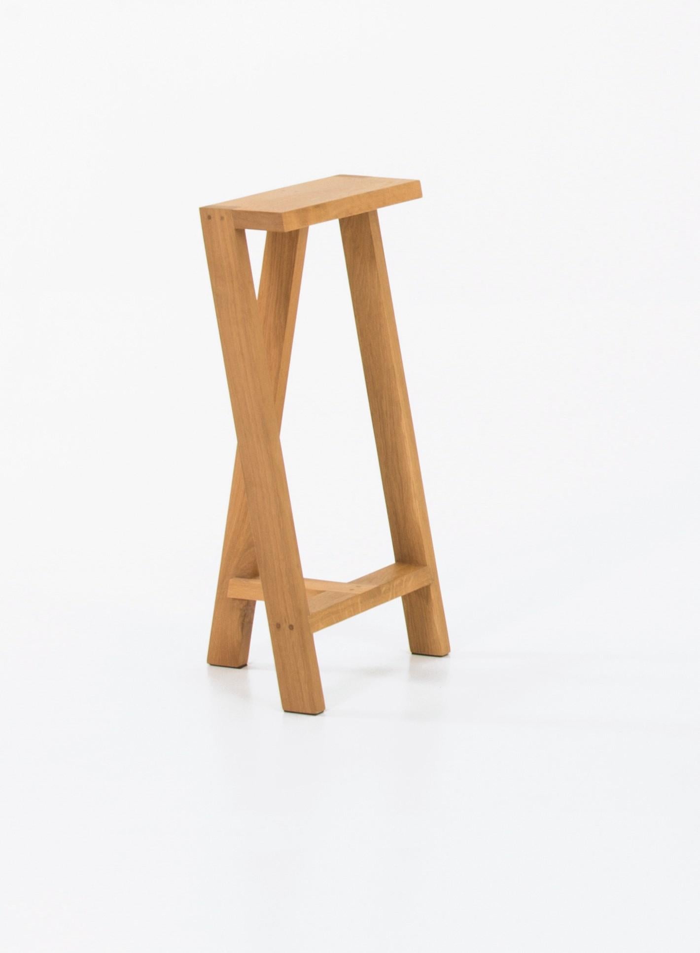 Medium Pausa oak stool by Pierre-Emmanuel Vandeputte
Dimensions: D 27 x W 35 x H 65 cm
Materials: oak wood
Available in burnt oak version and in 3 sizes.

Pausa is a series of stools; 45cm, 65cm, or 80cm of assembled oak pieces. 
The narrow
