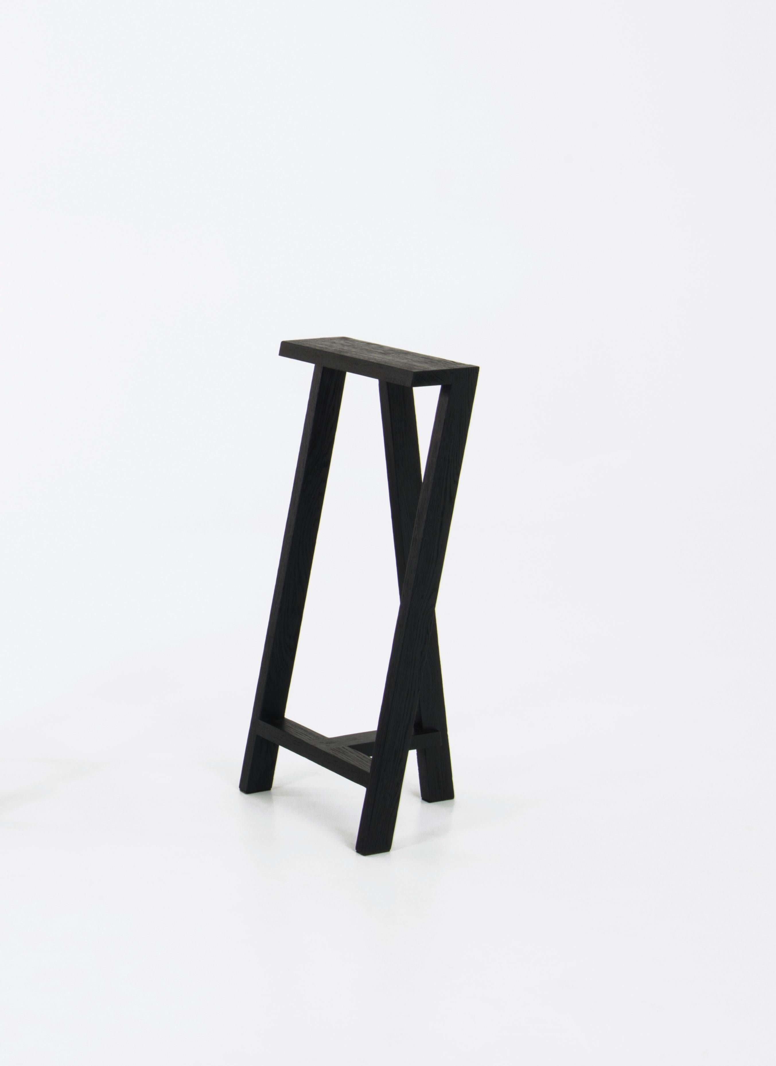 Medium Pausa oak stool by Pierre-Emmanuel Vandeputte
Dimensions: D 27 x W 35 x H 65 cm.
Materials: Burned oak wood.
Available in natural oak version and in 3 sizes.

Pausa is a series of stools; 45cm, 65cm, or 80cm of assembled oak pieces.