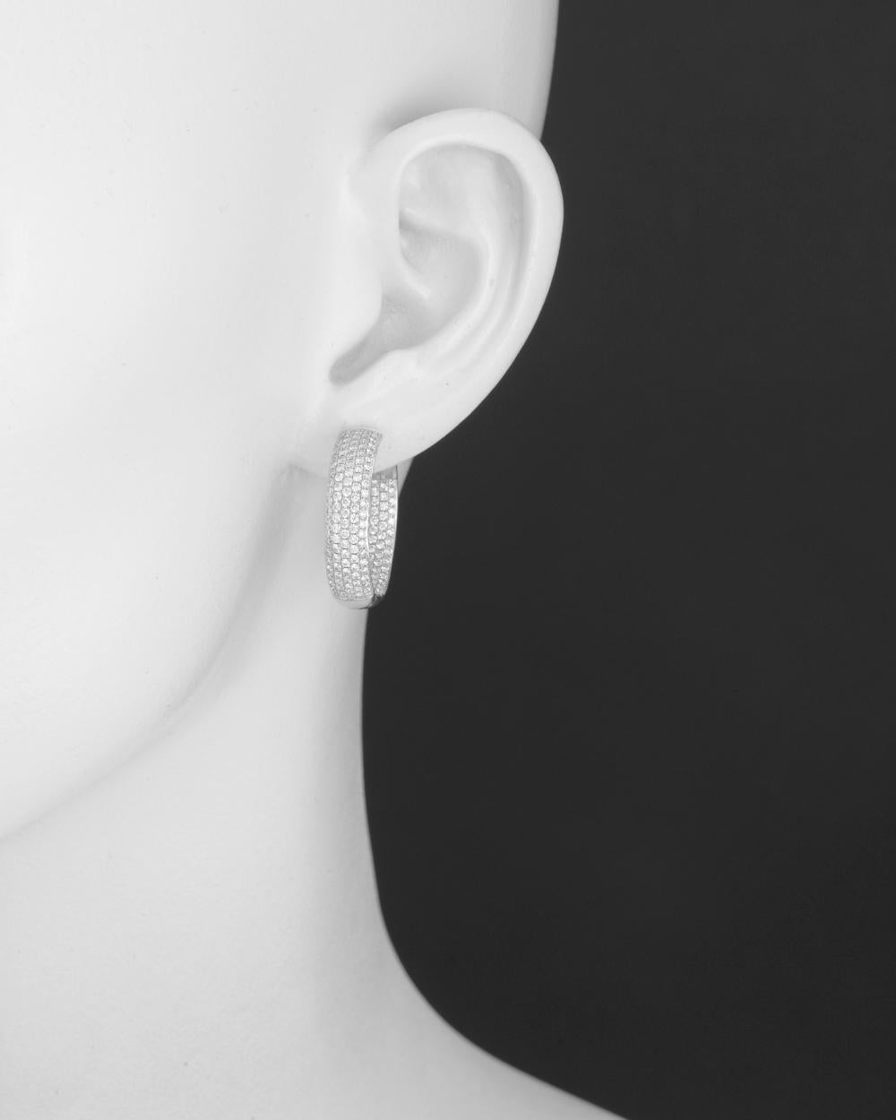 Round-shaped hoop earrings in 18k white gold with pavé diamonds. 362 round-cut diamonds (G-H color) weighing approximately 2.60 total carats set in five rows to the front inside and outside the hoop. Hinged with posts. 1