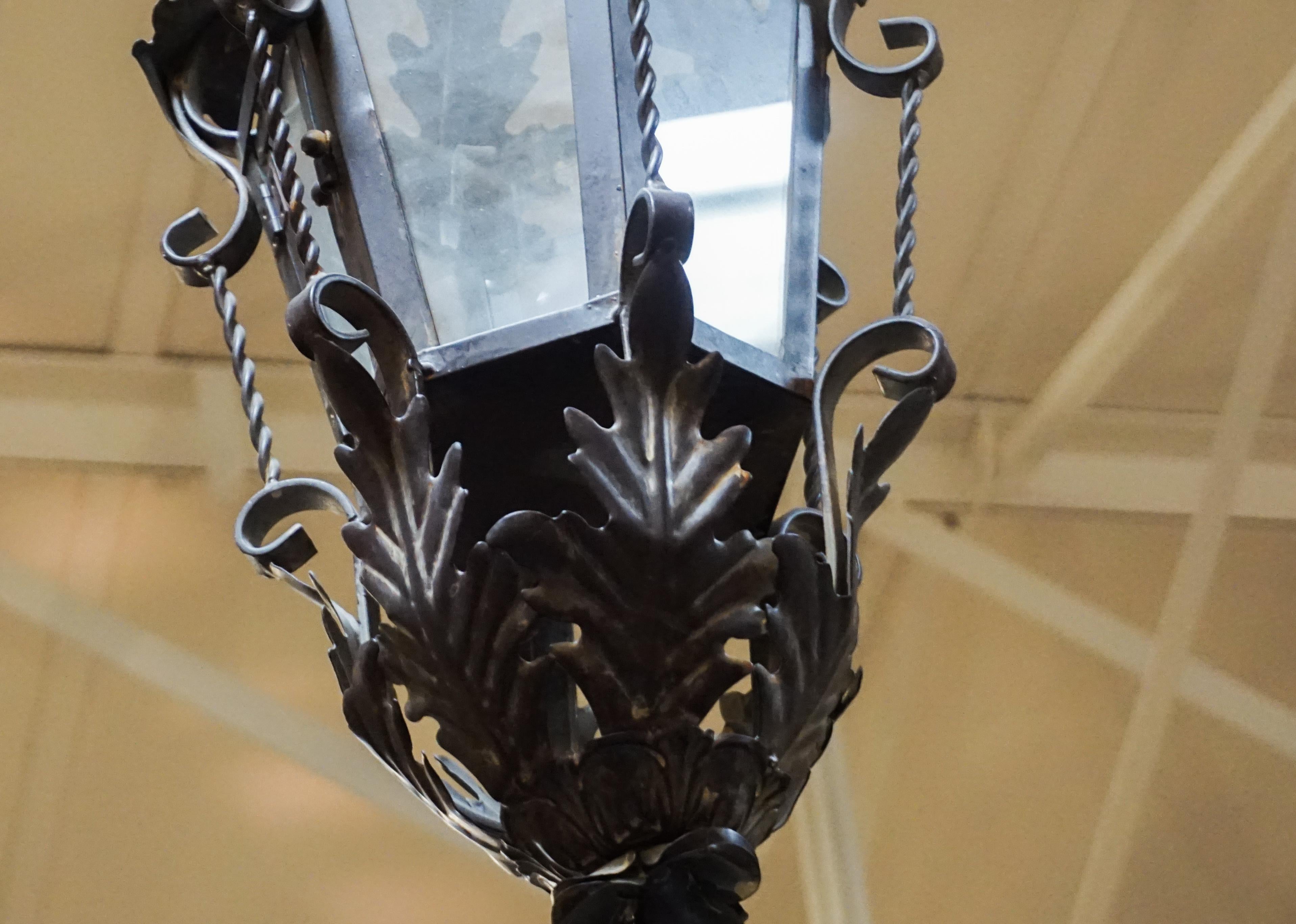 This French porch lantern is made of handwrought iron with acanthus leaf decor. Arm included. 

Measurements: 13