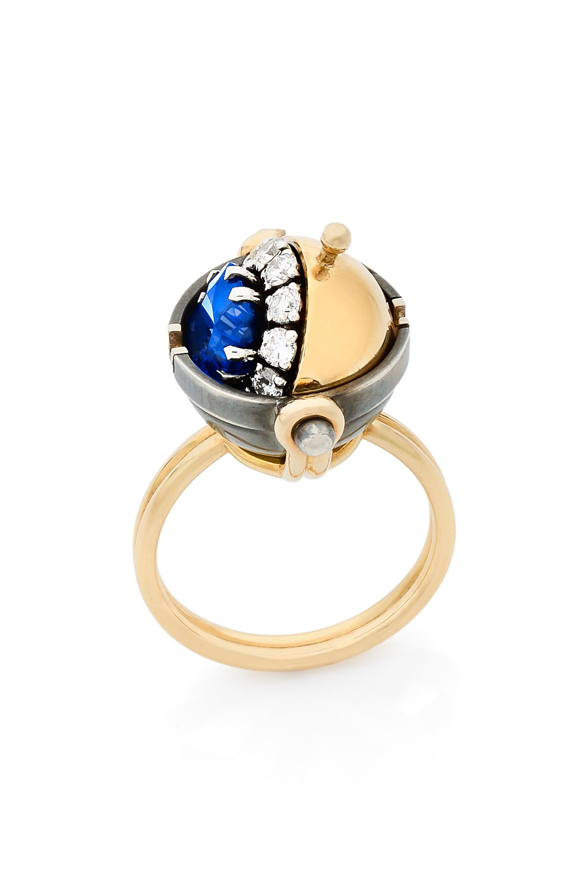 Gold and distressed silver ring. Rotating sphere set with a star diamond revealing a cushion-cut sapphire surrounded by diamonds.

Details:
Sapphire : 2.15 cts, 7x7
12 Diamonds : 0.4 cts
18k Yellow Gold : 9 g
Distressed Silver :  3g 
Made in France