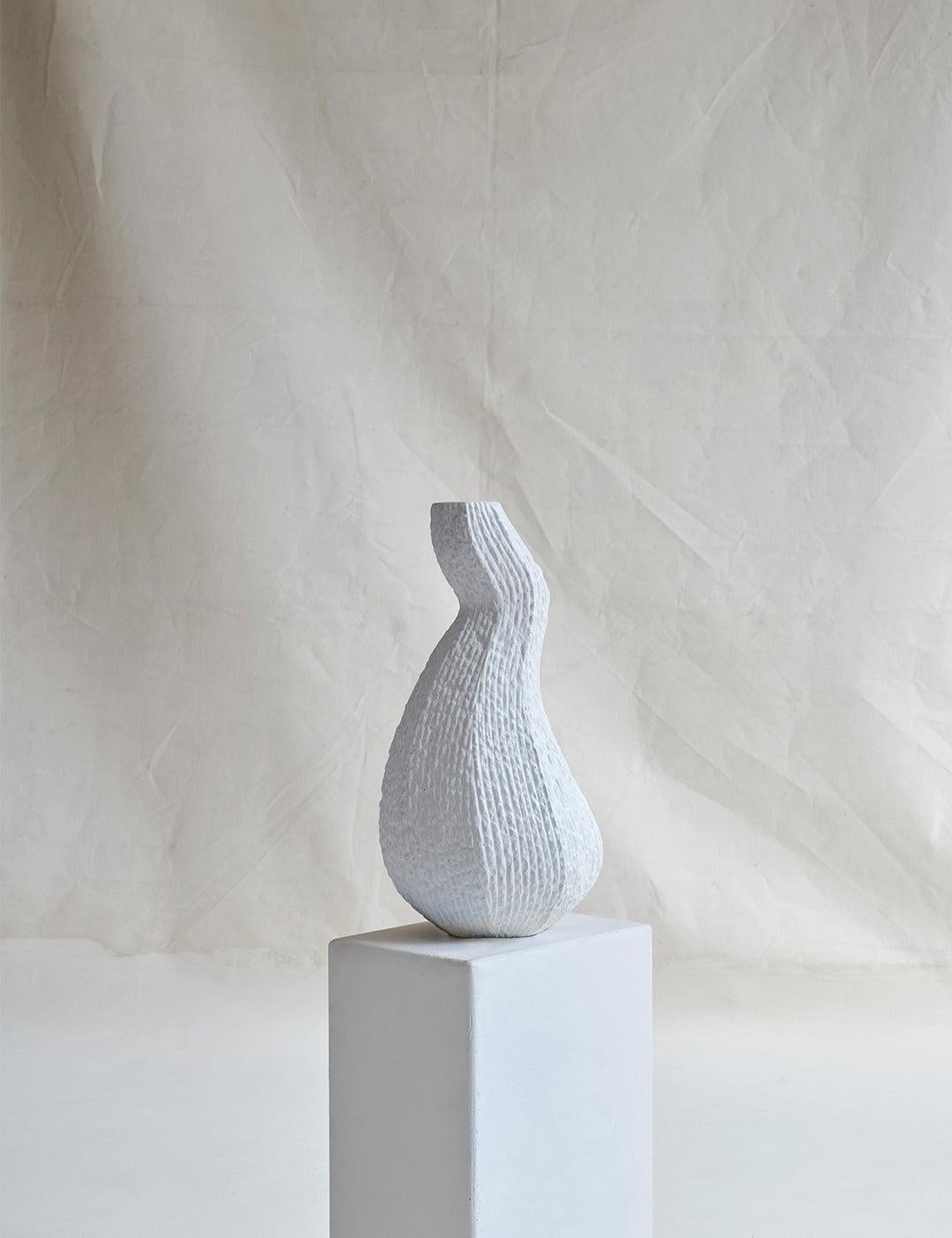 A medium-sized sculptural vessel that brings grandeur to any space it occupies, noted for its organic architecture, striking curves, and natural texture. 

For indoor or outdoor use.

Dimensions (in): 9