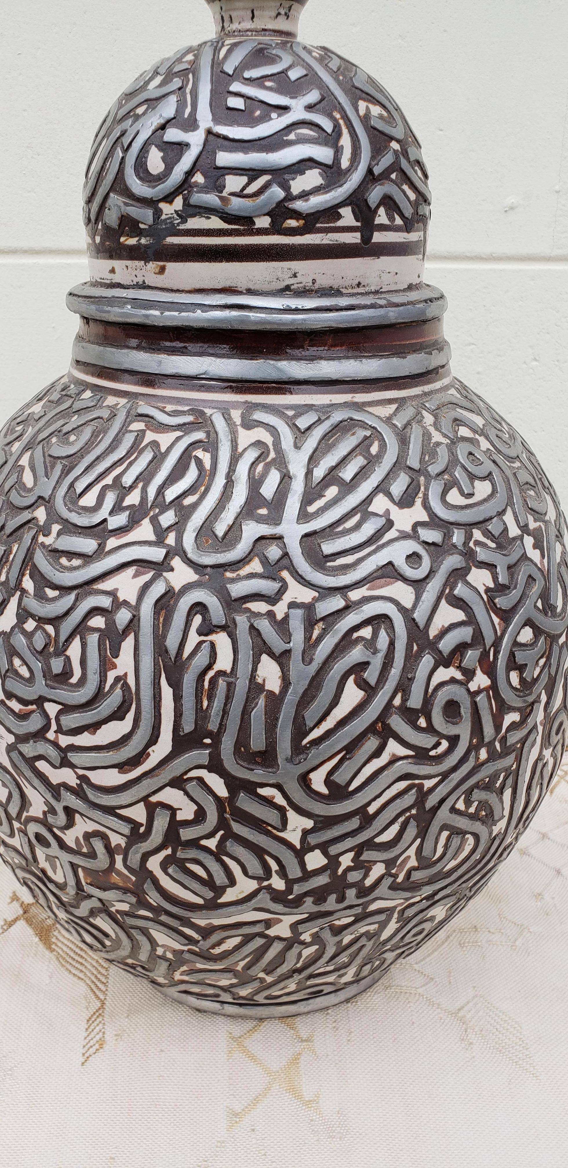 Made in Fez, Morocco, this incredible silver vase is adorned with relief metal, giving it a very exotic look, and making it a great add-on to any decor. Can be used as a beautiful centrepiece, above a mantle, a shelf, or a cabinet / armoire. Very