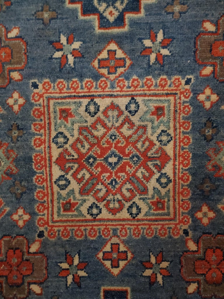 We carry some of the best Afghan bedside rugs, and if you are willing to give your room a colorful new look with one of our stunning carpets, we are here to help. This one measures approximately 49