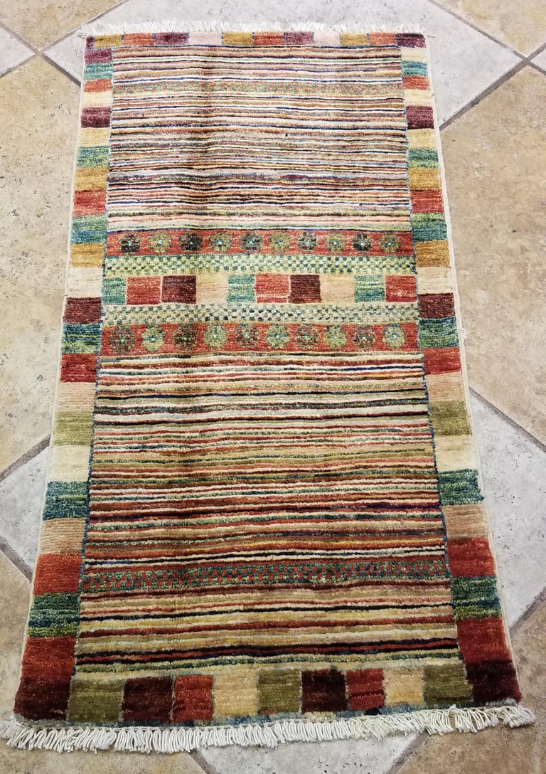 We carry some of the best Afghan bedside rugs, and if you like to give your bedroom a colorful new look with one of our stunning carpets, we are here to help. This one measures approximately 39