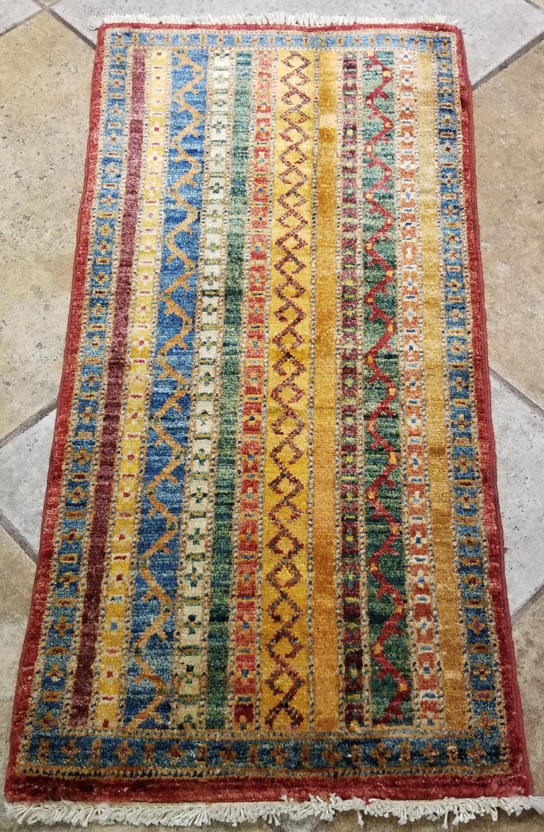 We carry some of the best Afghan bedside rugs, and if you are willing to give your bedroom a colorful new look with one of our stunning carpets, we are here to help. This one measures approximately 40