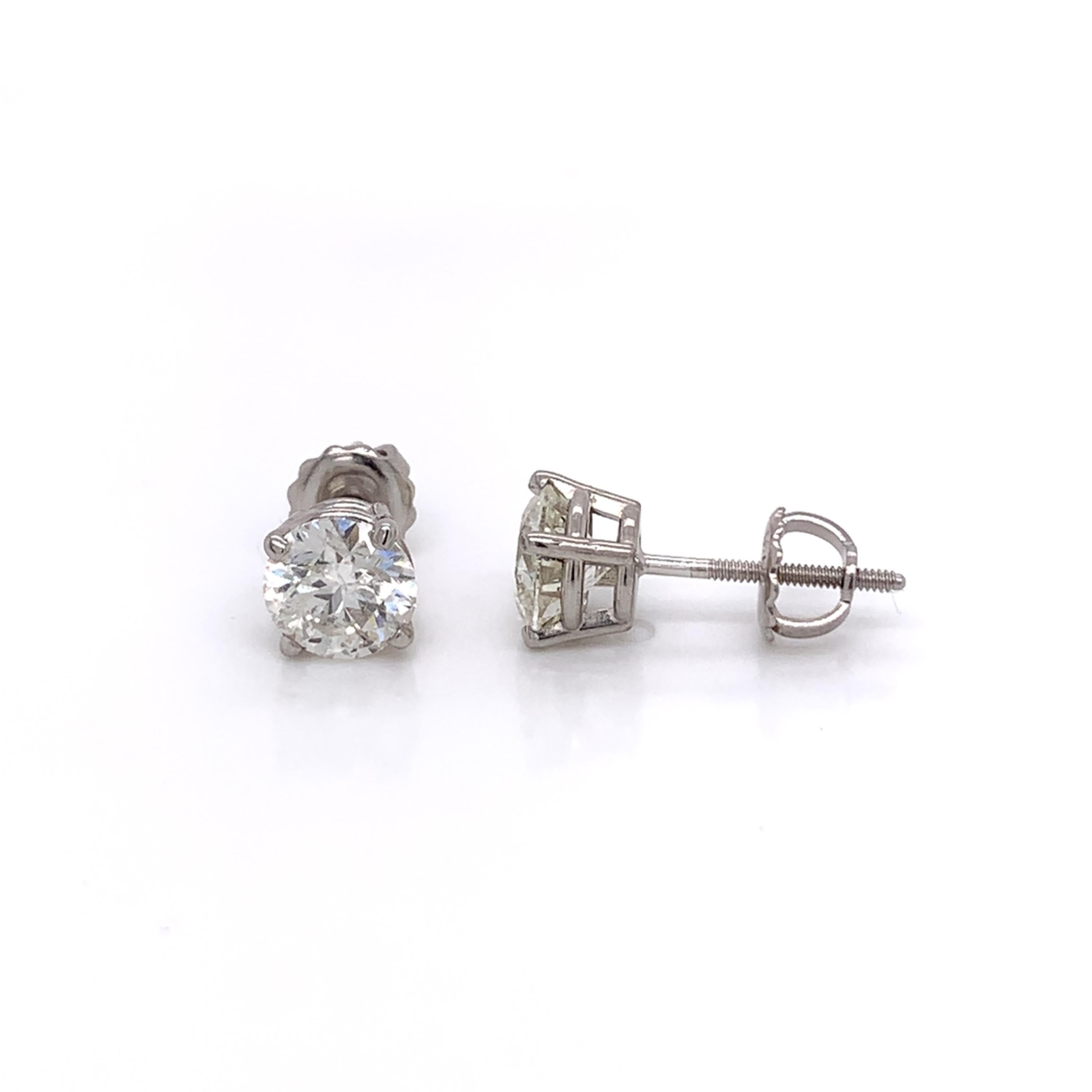2.06 Carat diamond stud earrings made with real/natural brilliant cut diamonds. Total Diamond Weight: 2.06 carats. Diamond Quantity: 2 round diamonds. Color: G-H. Clarity: SI2-SI3. Mounted on 18 karat white gold screw back setting.