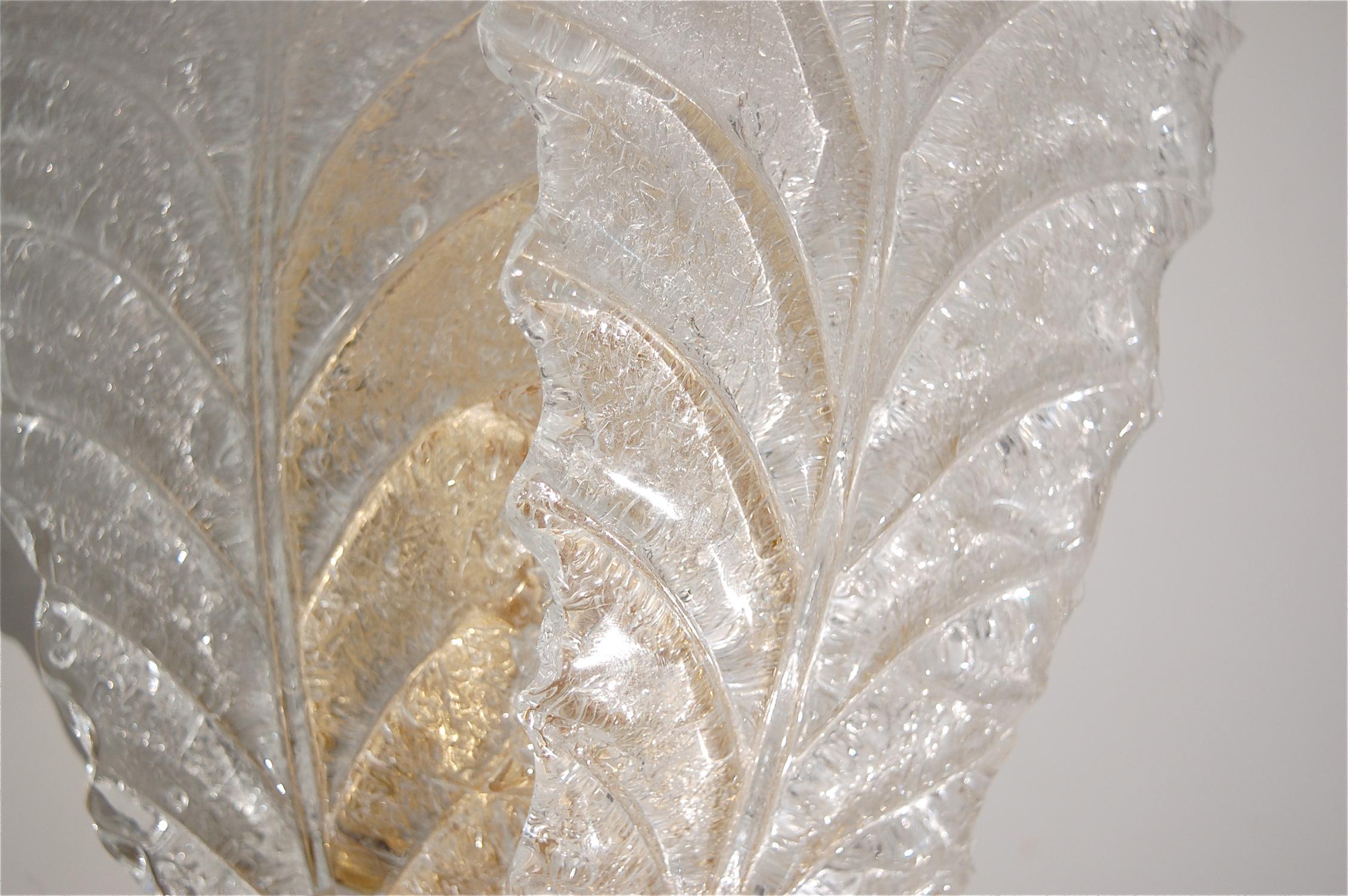 A single, medium sized, wall mounted, Murano glass leaf wall sconce in the style of Barovier & Toso. Three individual leaves are attached to a gold colored metal backplate. The reverse side of the leaf has a textured surface which diffuse the light