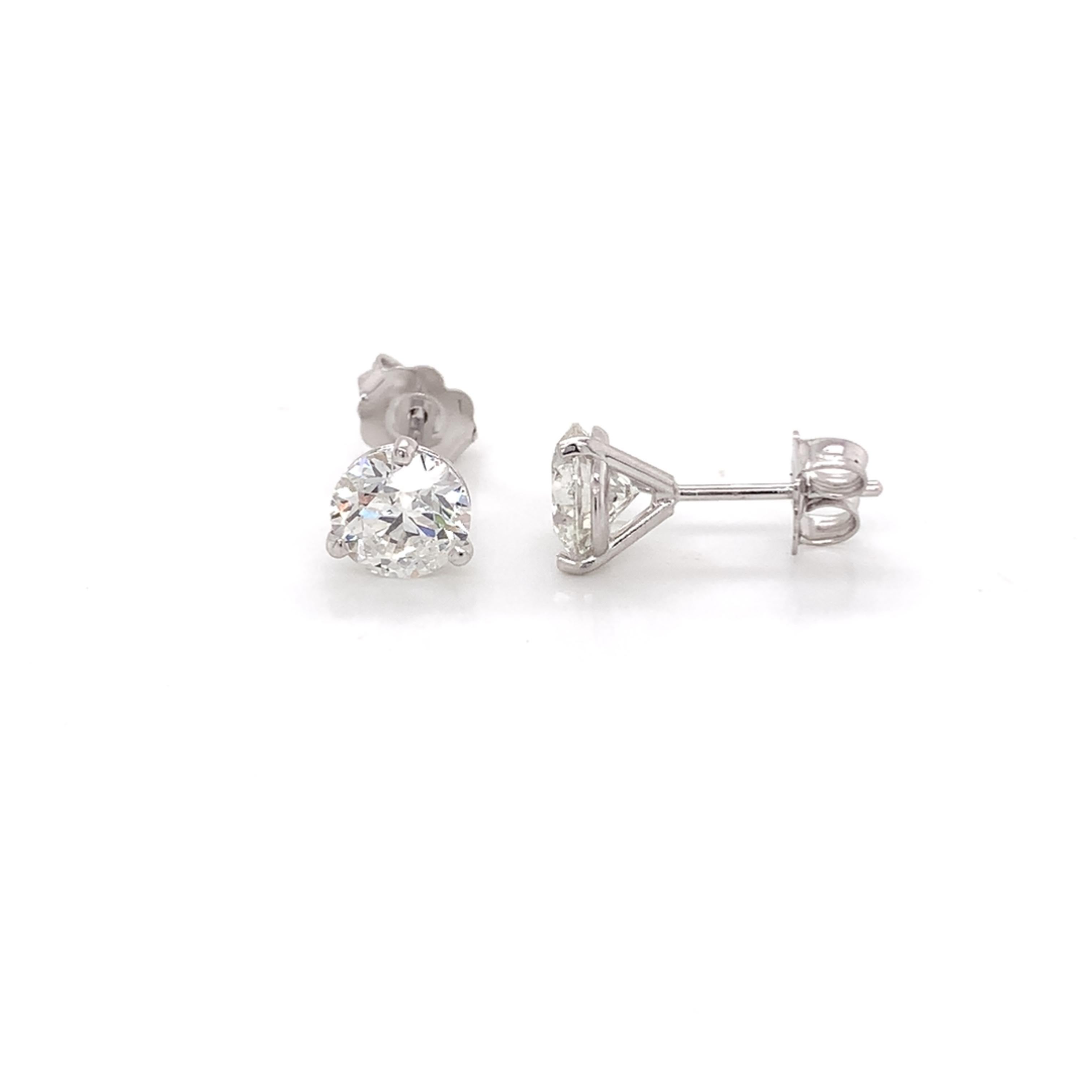 Diamond stud earrings made with real/natural brilliant cut diamonds. Total Diamond Weight: 2.04 carats. Diamond Quantity: 2 round diamonds. Color: H-I. Clarity: SI2-SI3. Mounted on 18kt white gold, push-back setting.