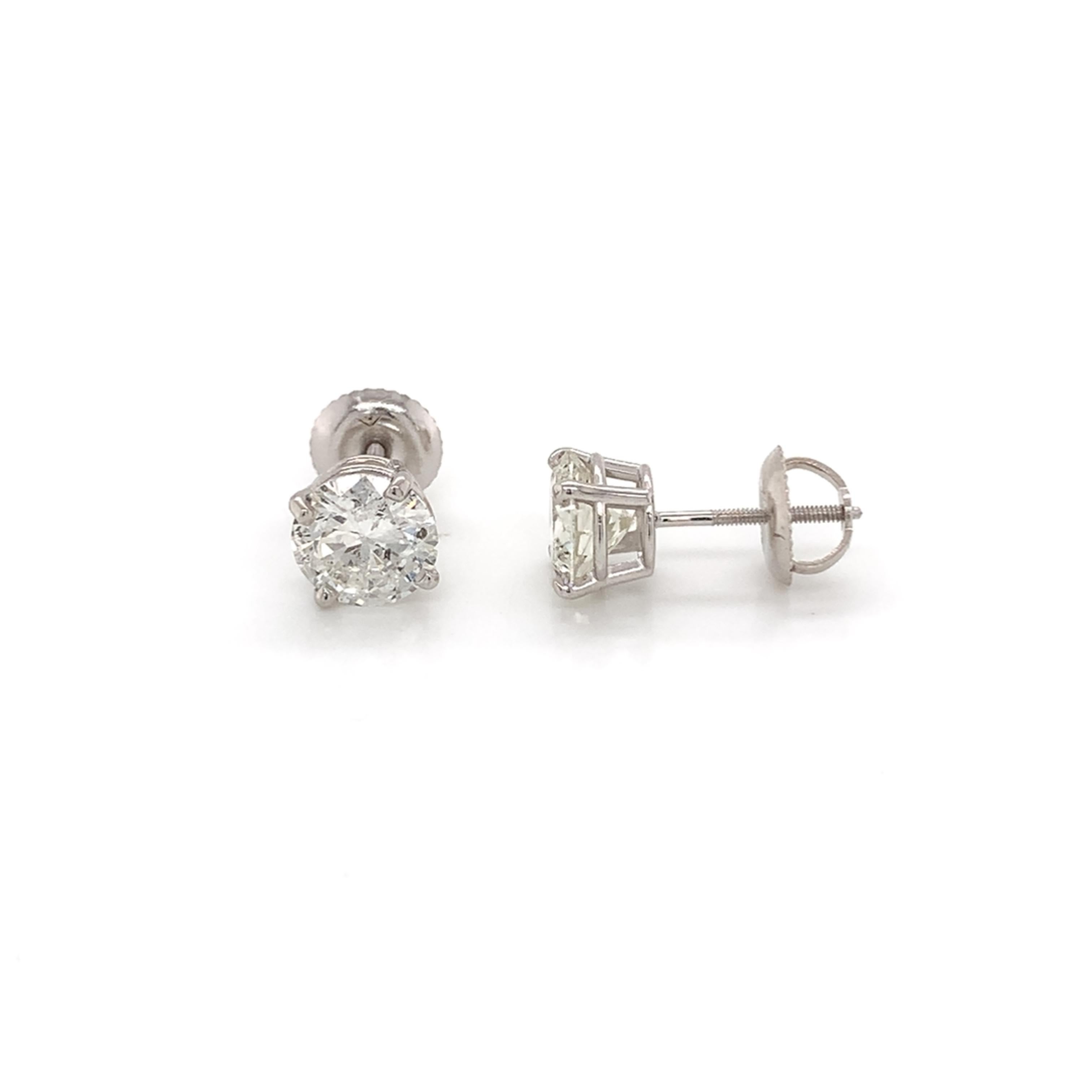 Diamond stud earrings made with real/natural brilliant cut diamonds. Total Diamond Weight: 2.04 carats. Diamond Quantity: 2 round diamonds. Color (approx): F-G. Clarity (approx): SI3-I1. Mounted on 18kt white gold, screw-back setting.