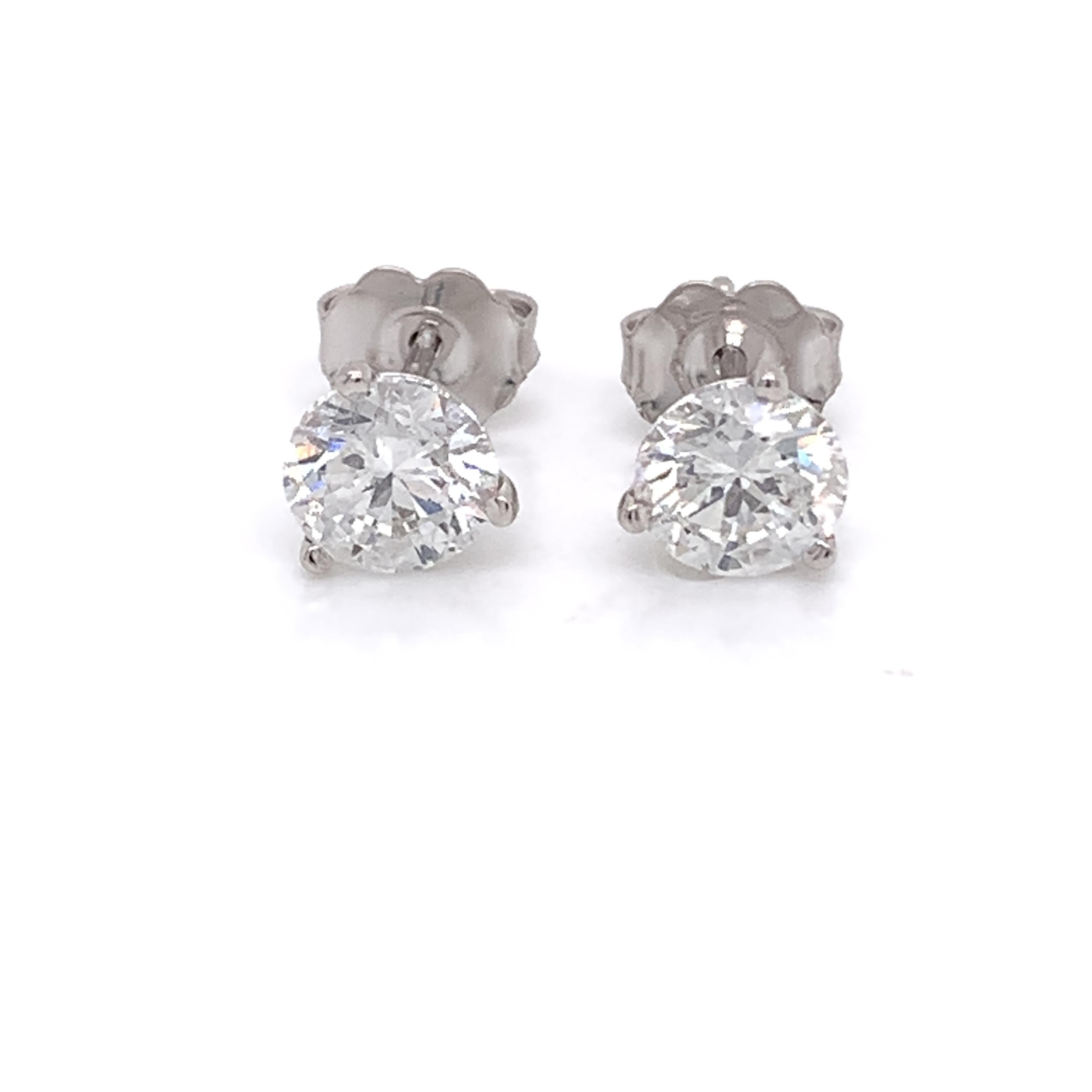Diamond stud earrings made with real/natural brilliant cut diamonds. Total Diamond Weight: 1.57 carats. Diamond Quantity: 2 round diamonds. Color: F-G. Clarity: SI2-SI3. Mounted on 18kt white gold push-back setting.