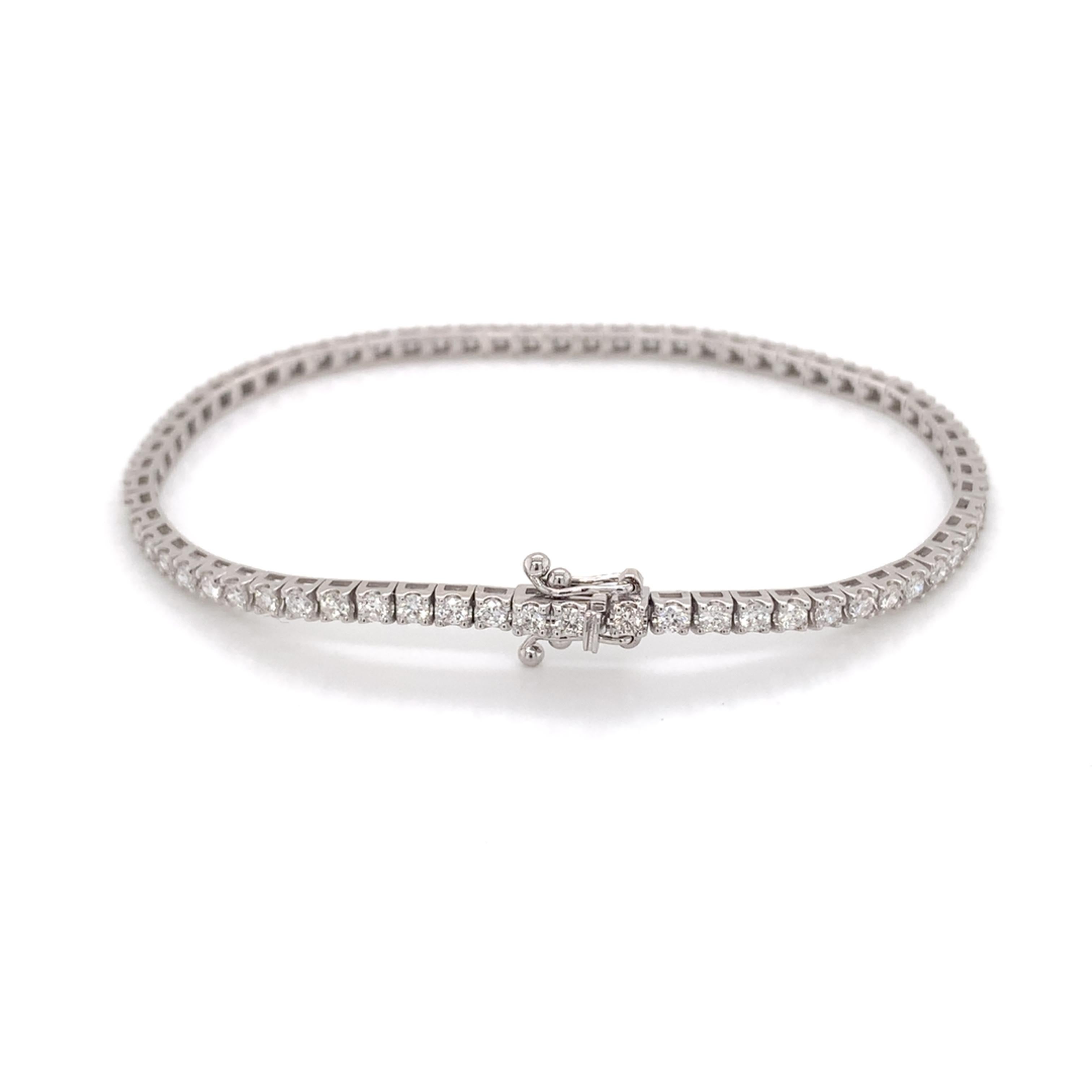 Medium sized tennis bracelet made with real/natural brilliant cut diamonds. Total diamond weight: 2.04 carats. Diamond Quantity: 66 round diamonds. Color: G. Clarity: SI. Mounted on 18kt white gold.
