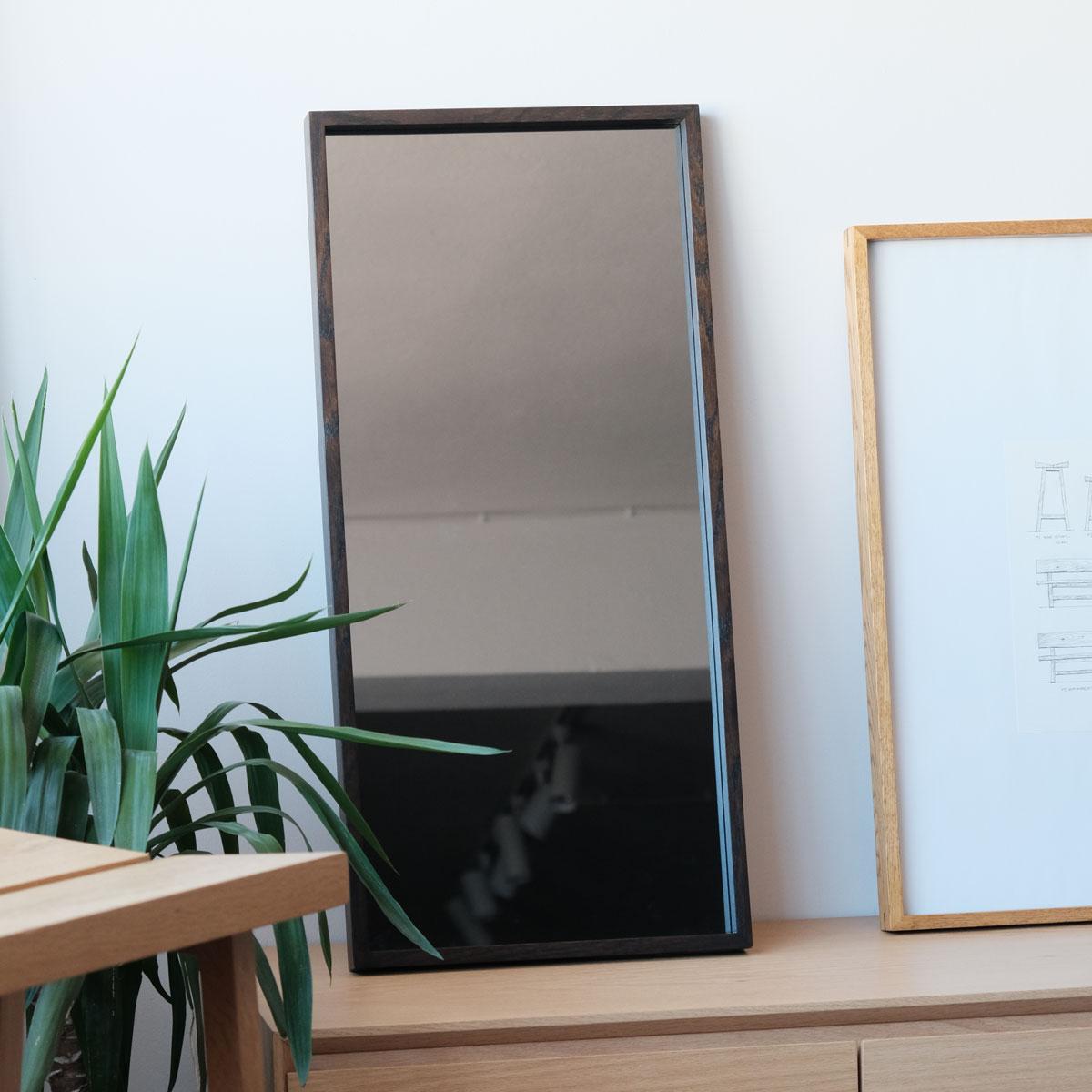 The EDGE Series Medium Smoked Mirror blends modern elegance with the warmth of natural oak, offering a timeless accessory for contemporary interiors. Framed with handcrafted solid oak, each piece showcases the unique grain patterns and tones of the