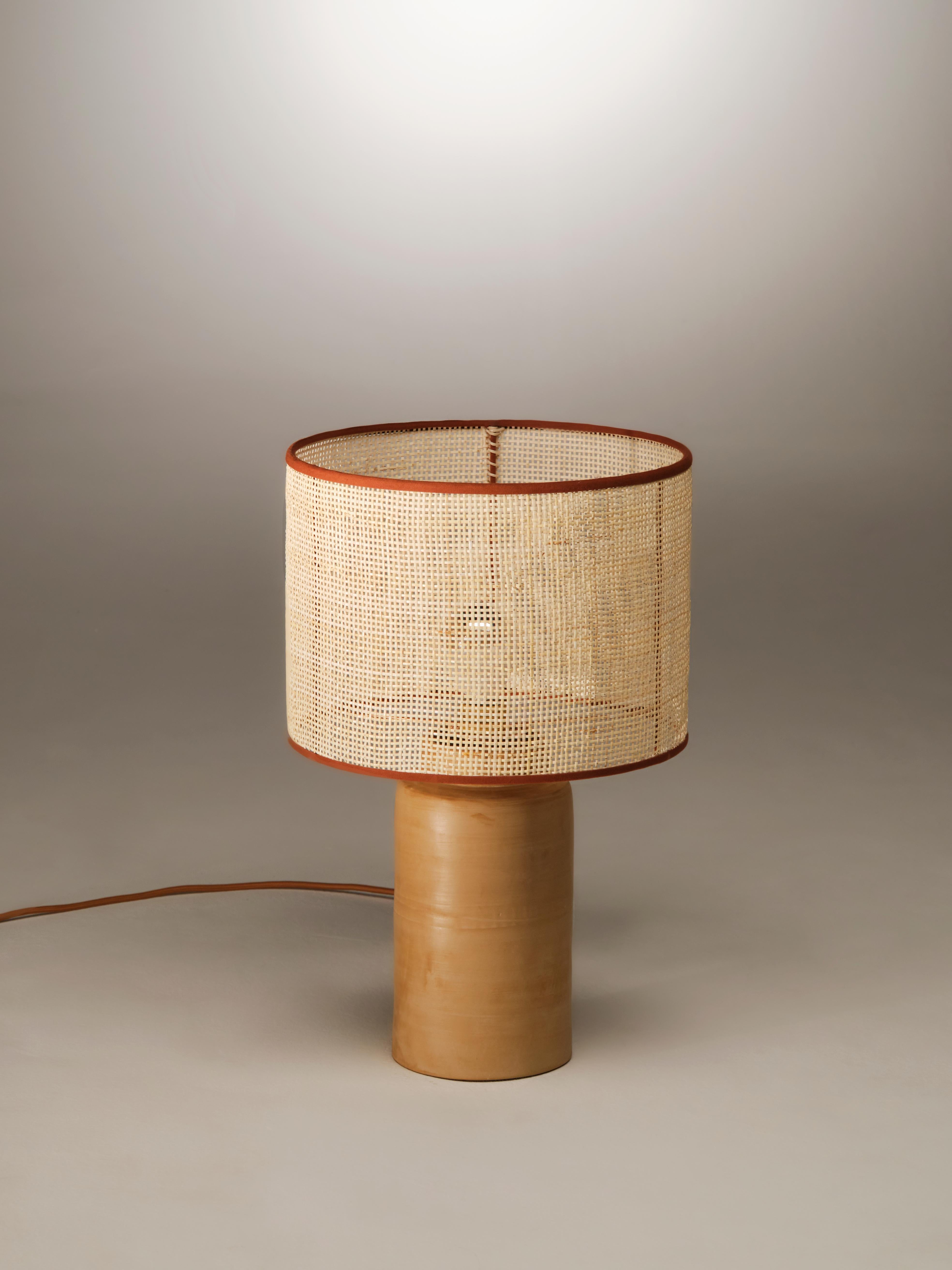 Medium Sonora Rattan Table Lamp by NASSI
Dimensions: W 30 x D 30 x H 45 cm. 
Materials: Lampshade: coated iron, Natural rattan, cotton trimmings
Base: wood-fired clay with beeswax finish.
Weight 2 kg

About: An established part of the handmade