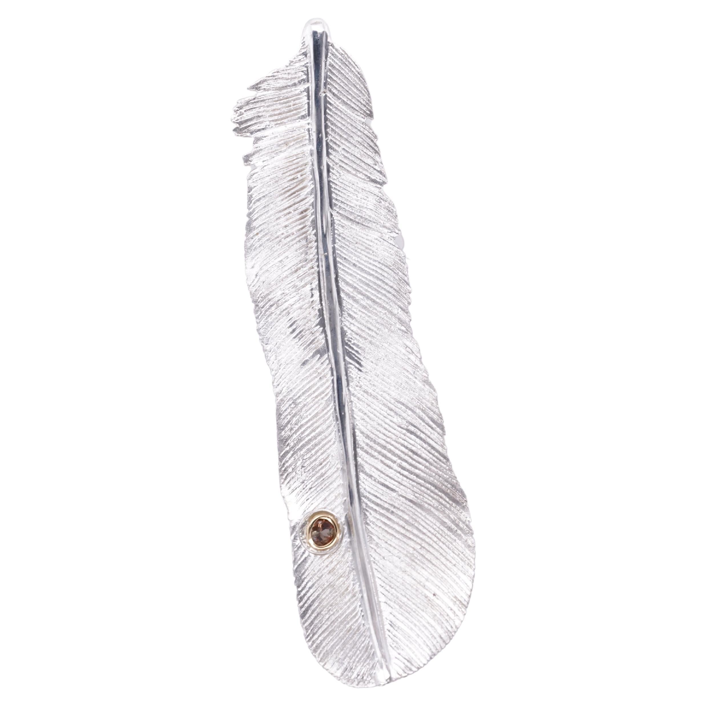 Medium Sterling Silver Detailed Feather Brooch with Andalusite detail set in 18K Yellow Gold Bezel, by Ashley Childs

This feather was originally carved by 