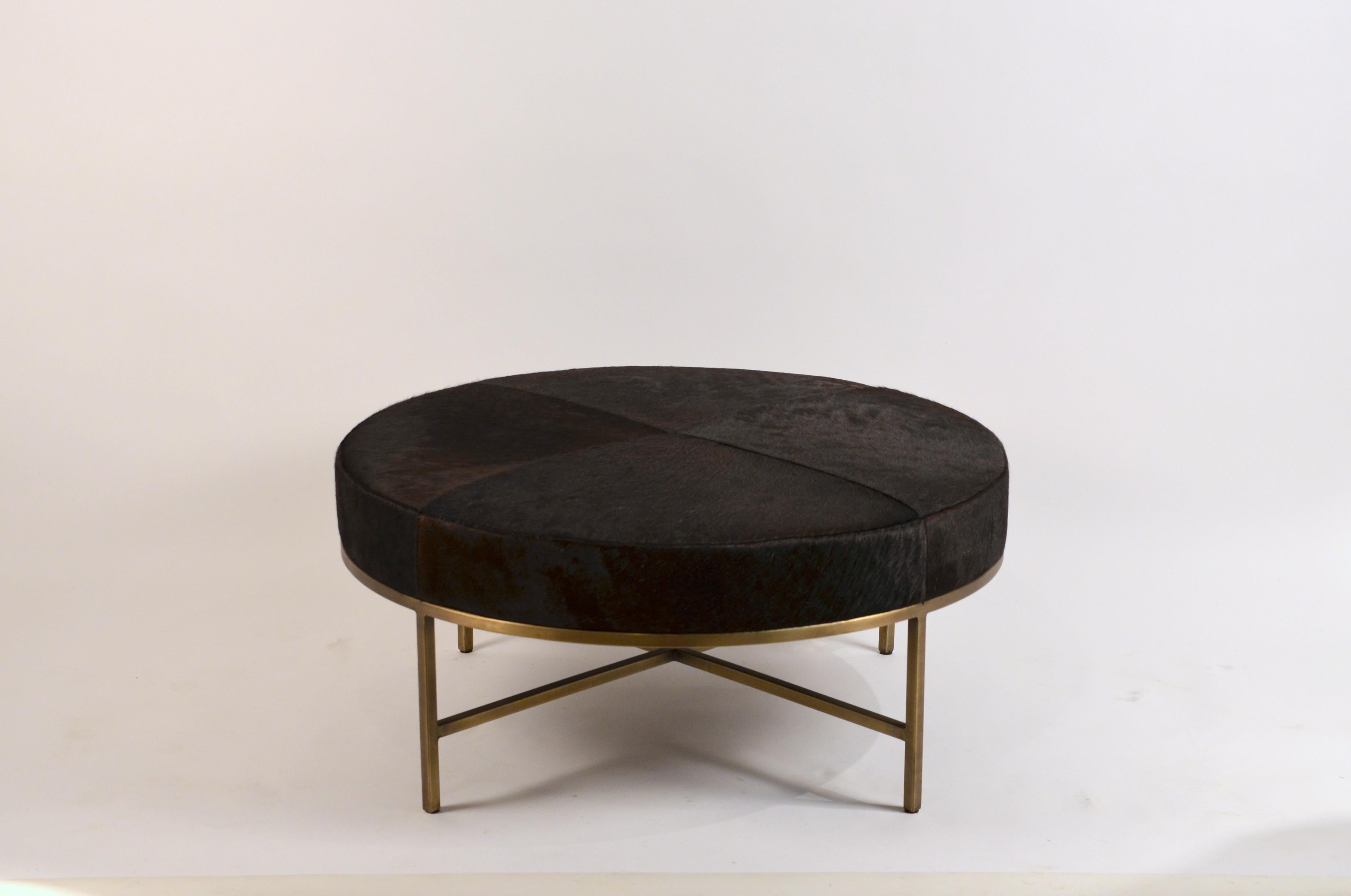 Chic 'Tambour' antiqued brass and dark brown hide ottoman by Design Frères.

38 in. diameter x 16.5 in. tall (other sizes available).

Upholstered on the firmer side, so it can also be used as a coffee table, with a tray, to place books, etc.