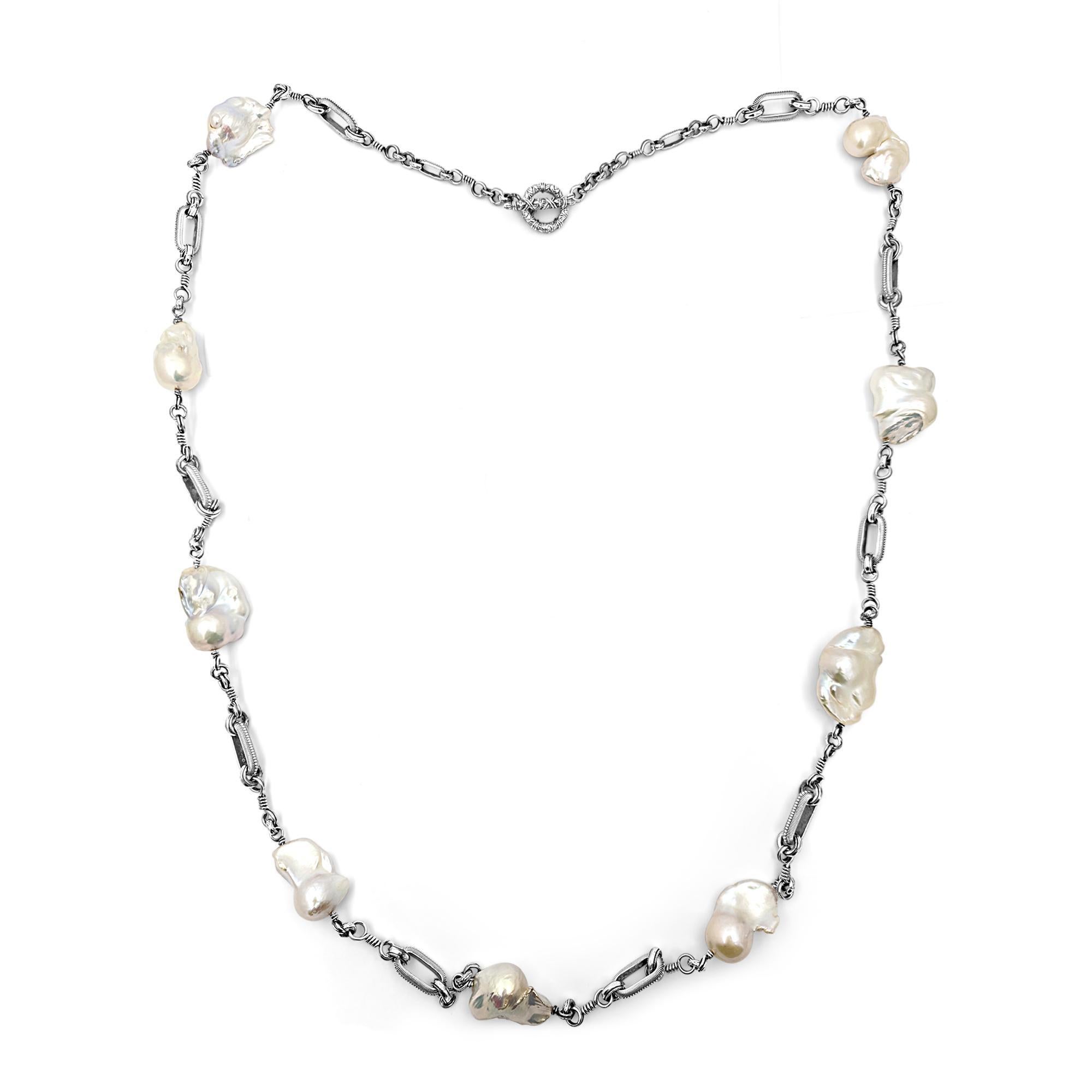 Indulge in the timeless elegance of the Medium White Baroque Pearl Long Single Strand Necklace with Medium Oval Chain Link, a masterpiece crafted by Stephen Dweck. Each lustrous baroque pearl, with its unique shape and iridescent glow, is