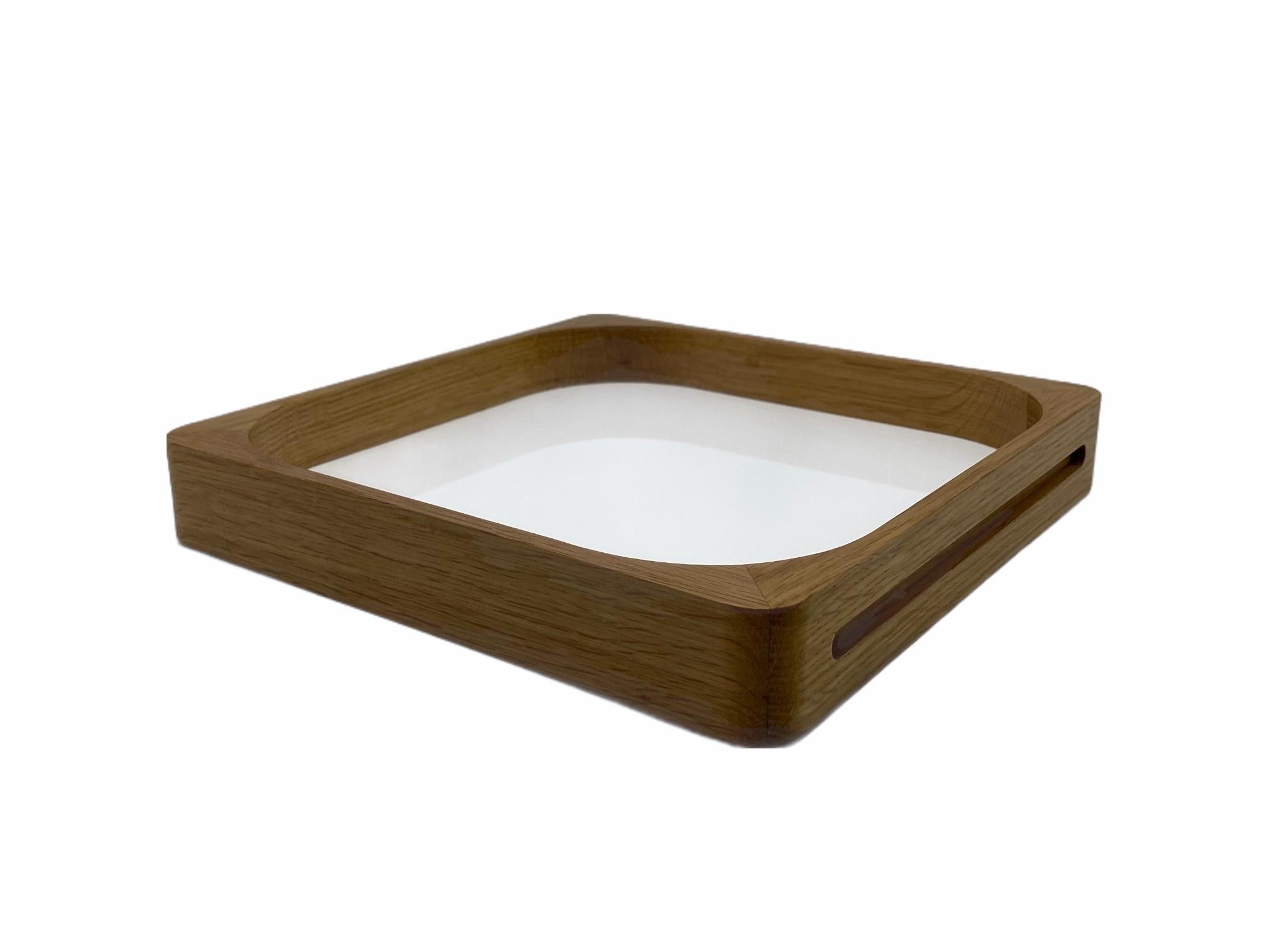 This classic, yet modern, craftsmanship based tray is made out of Oak wood and acrylic and was designed by GS in 2004. It can be used by clients as a cocktail tray as well as a very modern and practical serving tray, making it the perfect gift. The