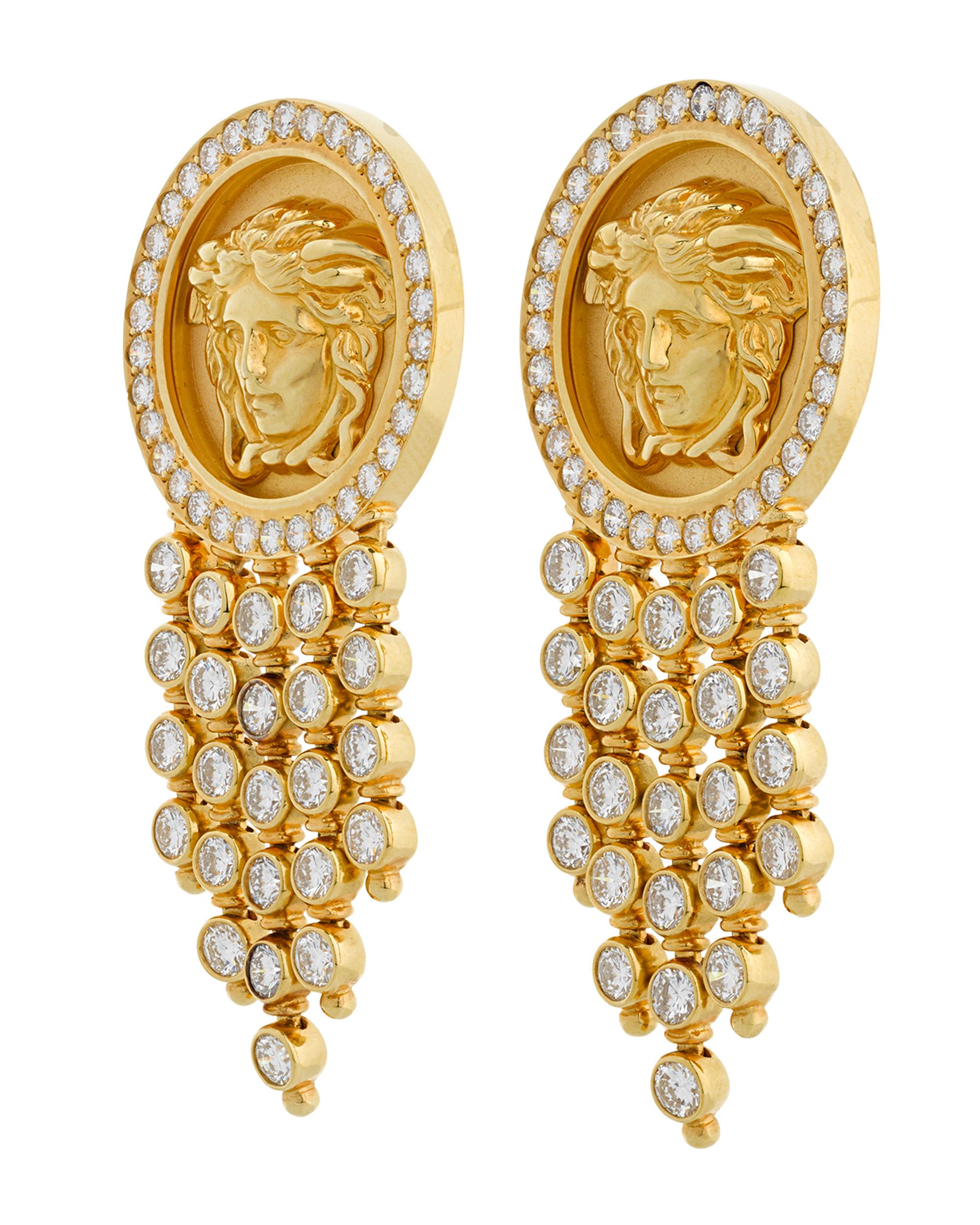 These striking dangle earrings by the legendary Italian designer Versace exhibit a bold beauty. Each earring features a medallion of the firm's logo - the head of the infamous figure from ancient Greek mythology, Medusa. As enthralling as the woman