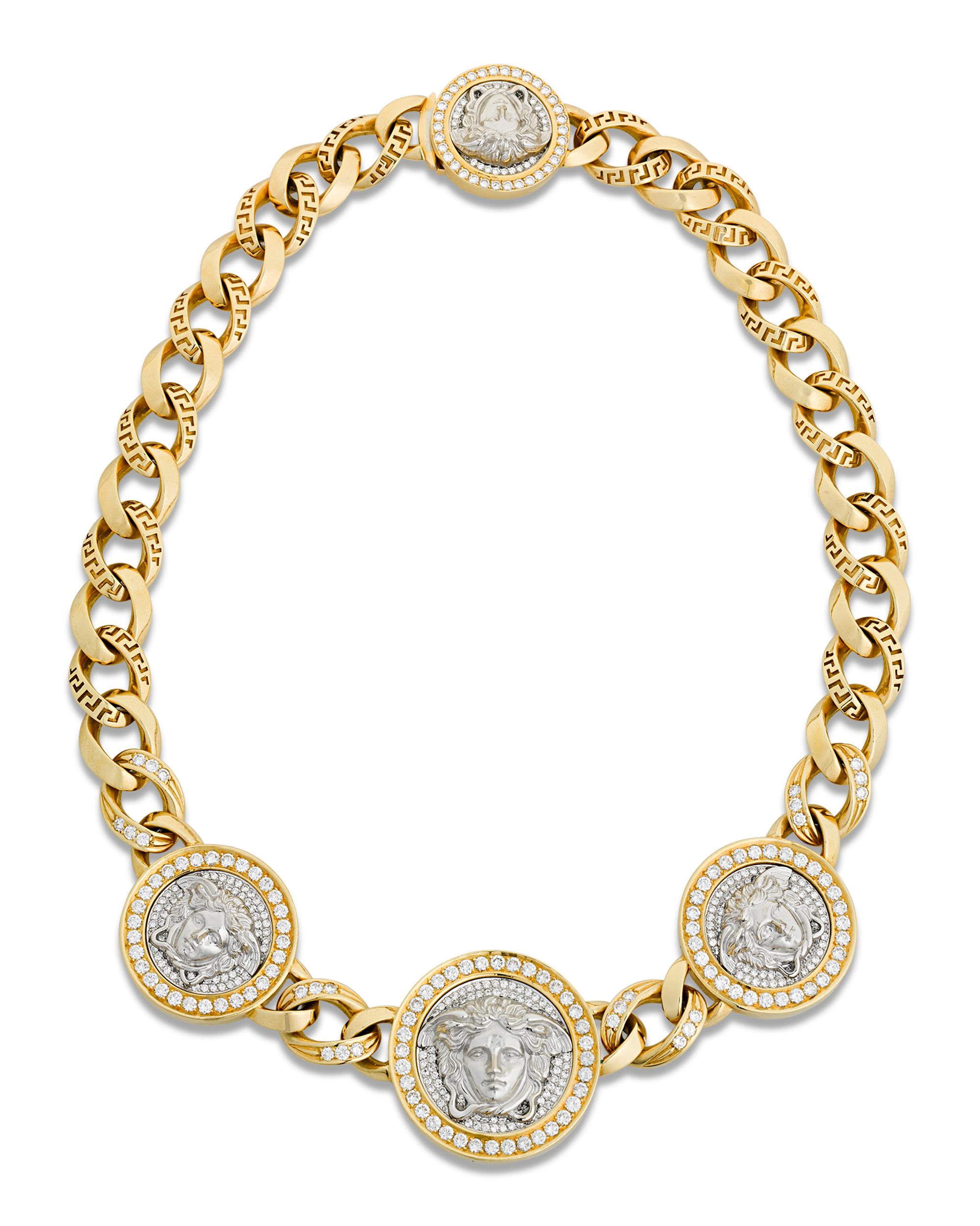 The iconic logo of the Italian firm is the focus of this incredible Versace necklace. The 18K gold piece comprises three medallions featuring the head of Medusa between large gold links. The medallions are encircled by white diamonds totaling