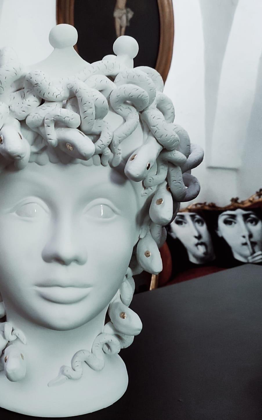 In Greek mythology, Medusa, was one of the three monstrous Gorgons, generally described as winged human females with living venomous snakes in place of hair. 
Those who gazed into her eyes would turn to stone. 
Medusa was beheaded by the Greek
