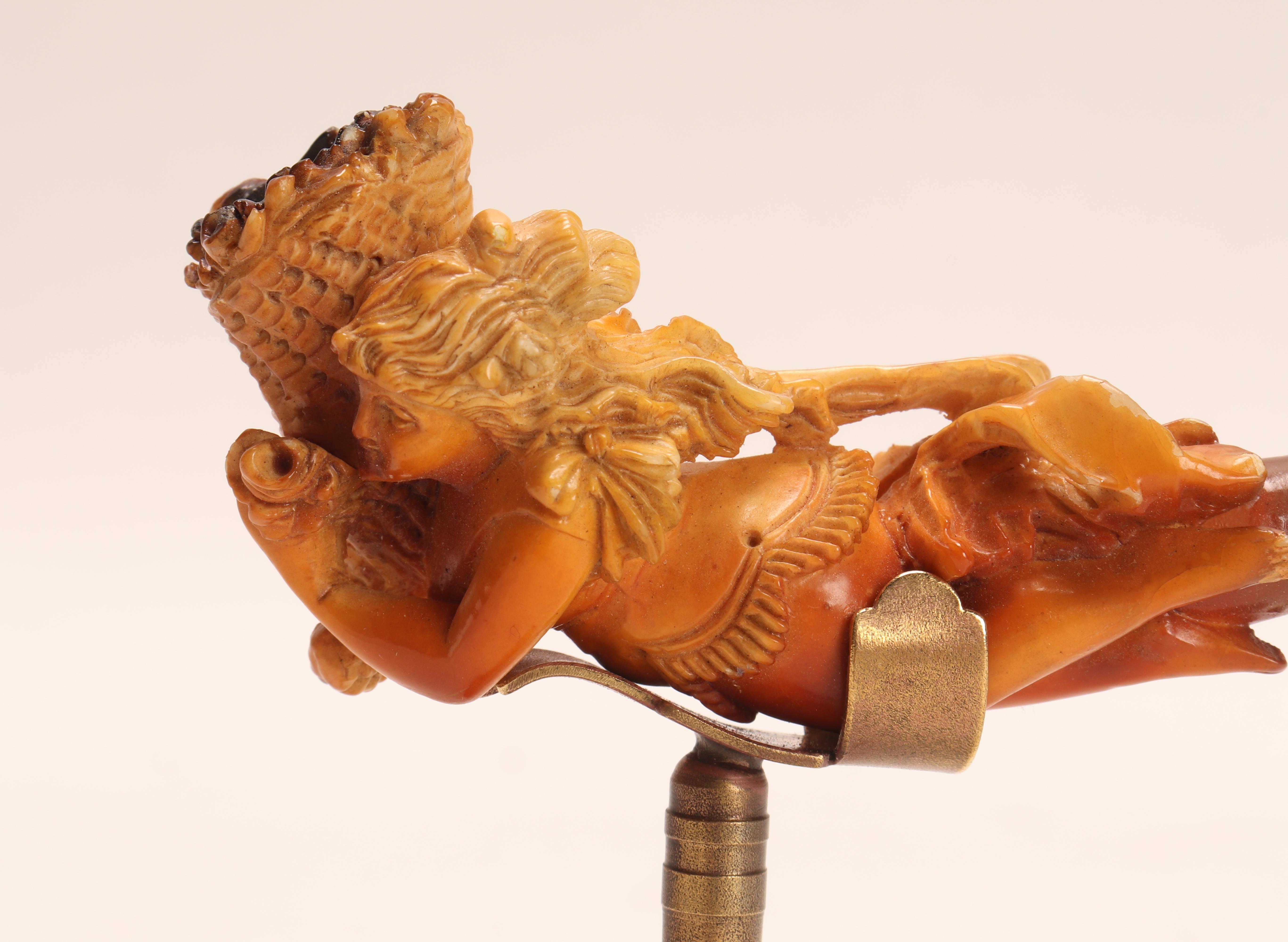 Tobacco taster pipe, made out of carved meershaum, with amber mouthpiece. A Goddess holds a cornucopia. Vienna, Austria circa 1890. Original case. (The stand is for photographic use only, not for sale).