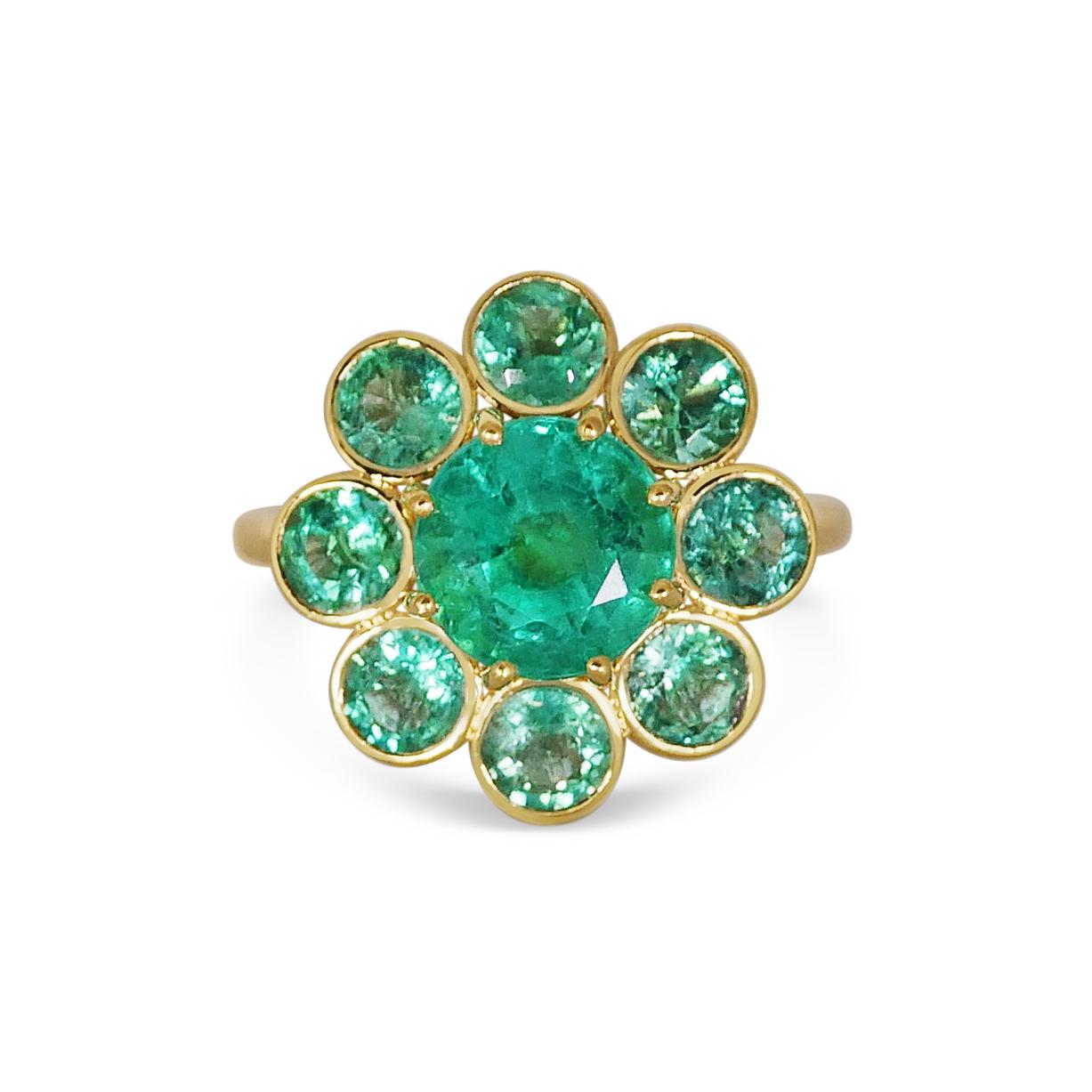 Composed of a gorgeous set of 5,44 carats matching Zambian Emeralds set on 18k Yellow Gold, our Mega-Marguerite are a fun oversized take on a flower ring. Our signature hand pierced gold lace structures the reverse of our ring. 

Certified in
