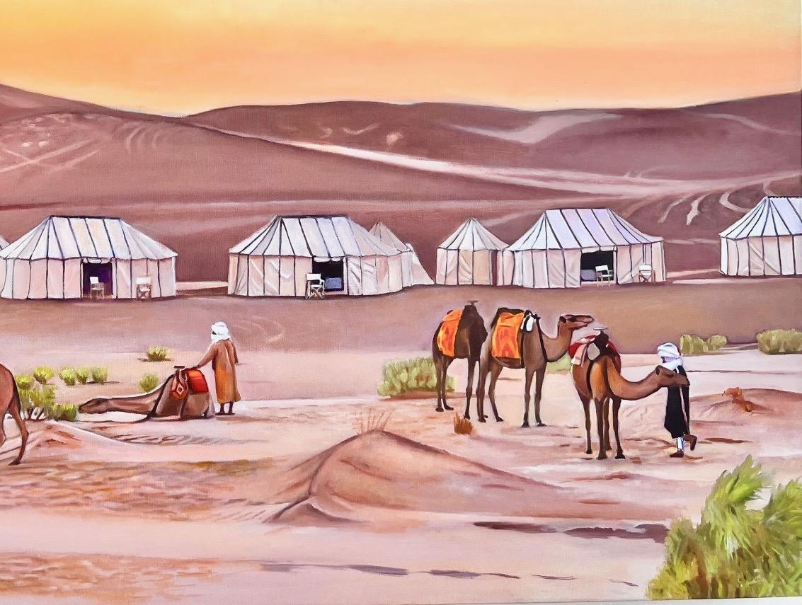 This desert landscape in Morocco is from a night spent at a camp in the Sahara.  The setting sun casts an warm light across the sand while the camels rest from the heat of the day.  Soon the dark will reveal a thousand stars and the light of Milky
