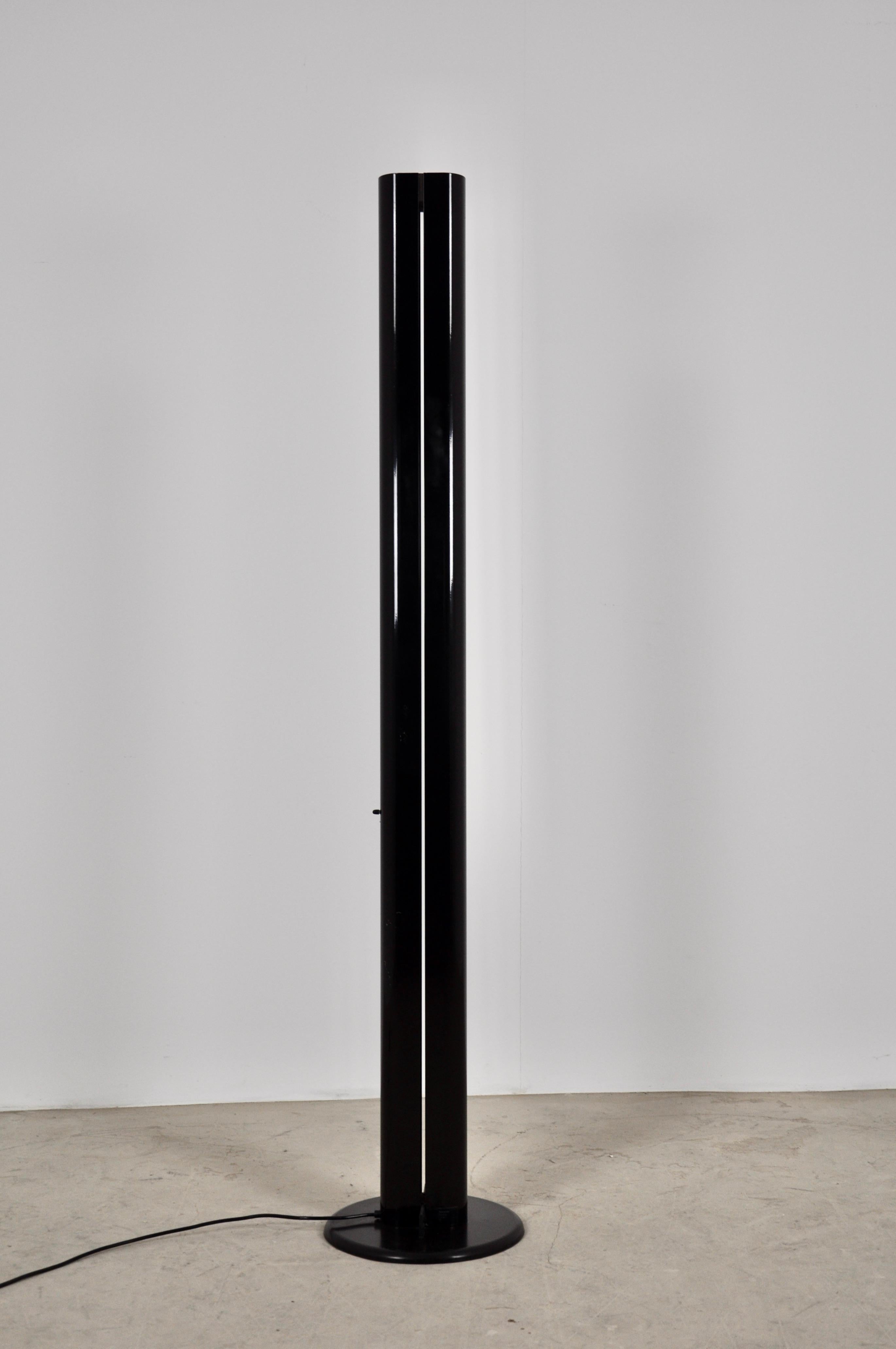 Metal floor lamp in black color. Wear and tear due to the time and age of the lamp.