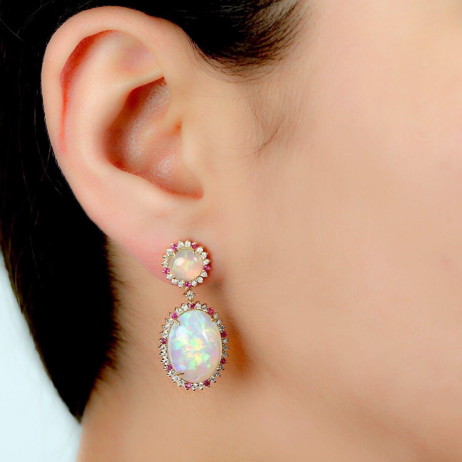 Cast in 14 karat gold. These earrings are hand set in 13.05 carats Ethiopian opal, .34 carats ruby, and .82 carats of sparkling diamonds. 

FOLLOW MEGHNA JEWELS storefront to view the latest collection & exclusive pieces. Meghna Jewels is proudly