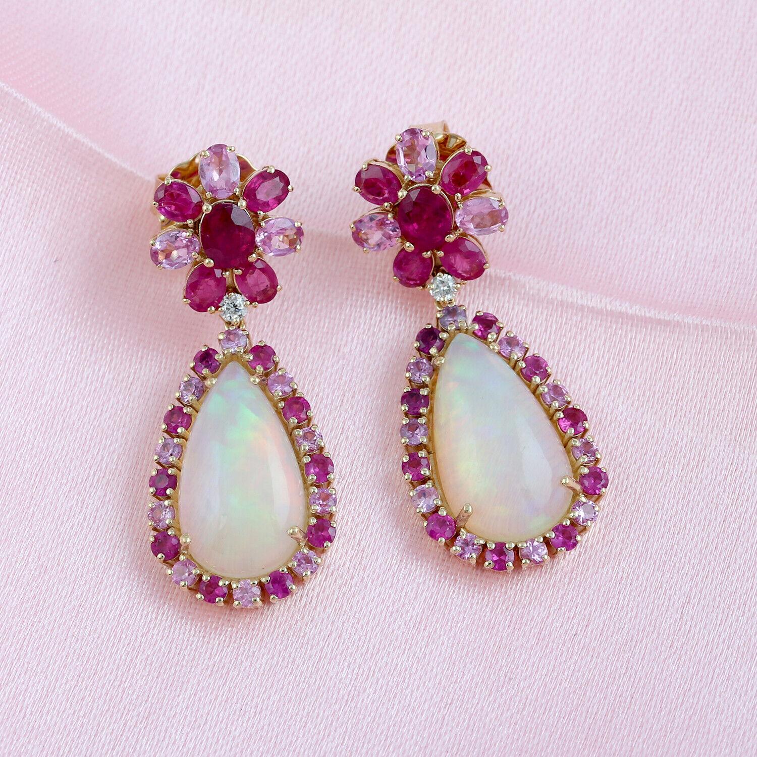 Cast in 14 karat gold. These earrings are handset in 13.51 carats Ethiopian opal, ruby, sapphire and .09 carats of sparkling diamonds. 

FOLLOW MEGHNA JEWELS storefront to view the latest collection & exclusive pieces. Meghna Jewels is proudly rated