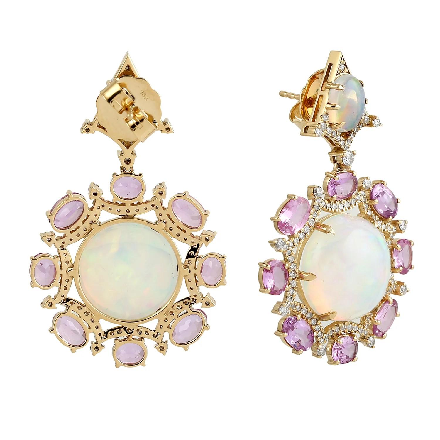 Cast in 18 karat gold, these exquisite earrings are hand set with  17.72 carats Ethiopian opal, 7.1 carats sapphire and 1.12 carats of glimmering diamonds. 

FOLLOW MEGHNA JEWELS storefront to view the latest collection & exclusive pieces. Meghna