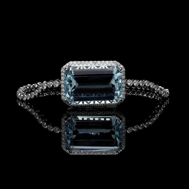 A stunning statement bracelet handmade in 18K gold. It is set in 19.26 carats Aquamarine and 1.98 carats of sparkling diamonds.

FOLLOW  MEGHNA JEWELS storefront to view the latest collection & exclusive pieces.  Meghna Jewels is proudly rated as a