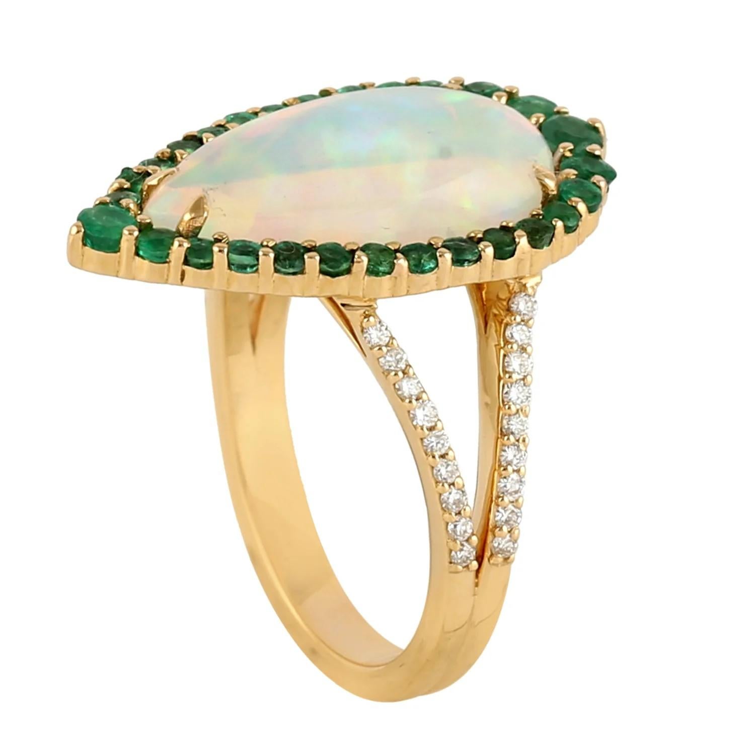This ring has been meticulously crafted from 14-karat gold.  It is hand set with 3.13 carat Ethiopian opal, .82 carats emerald & .22 carats of sparkling diamonds. 

The ring is a size 7 and may be resized to larger or smaller upon request. 
FOLLOW 