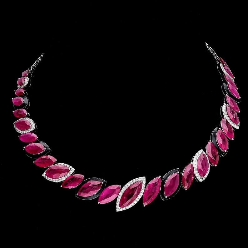 Cast from 18-karat gold, this exquisite necklace is hand set with 48.08 carats ruby and 1.85 carats of sparkling diamonds. Matching earrings available separately.

FOLLOW MEGHNA JEWELS storefront to view the latest collection & exclusive pieces.
