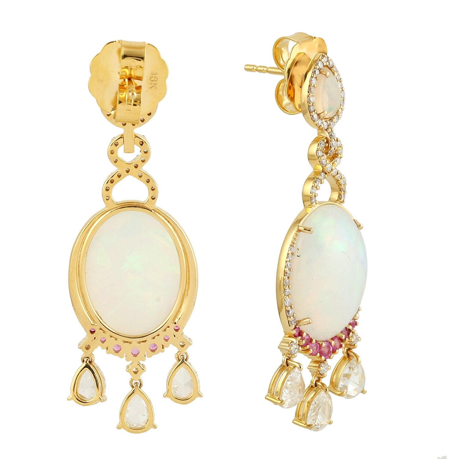 Cast in 14 karat gold. These earrings are hand set in 9.78 carats Ethiopian opal and topaz, 1.87 carats of sparkling diamonds. 

FOLLOW MEGHNA JEWELS storefront to view the latest collection & exclusive pieces. Meghna Jewels is proudly rated as a