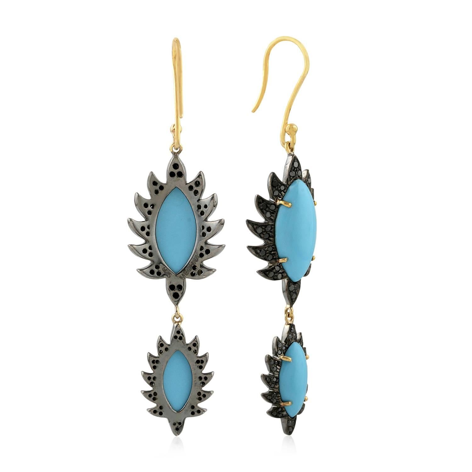 These beautiful drop earrings are cast in 18K gold and sterling silver. It is hand set in 7.54 carat turquoise and .71 carat of black diamonds, french hook closures. Framed in signature 