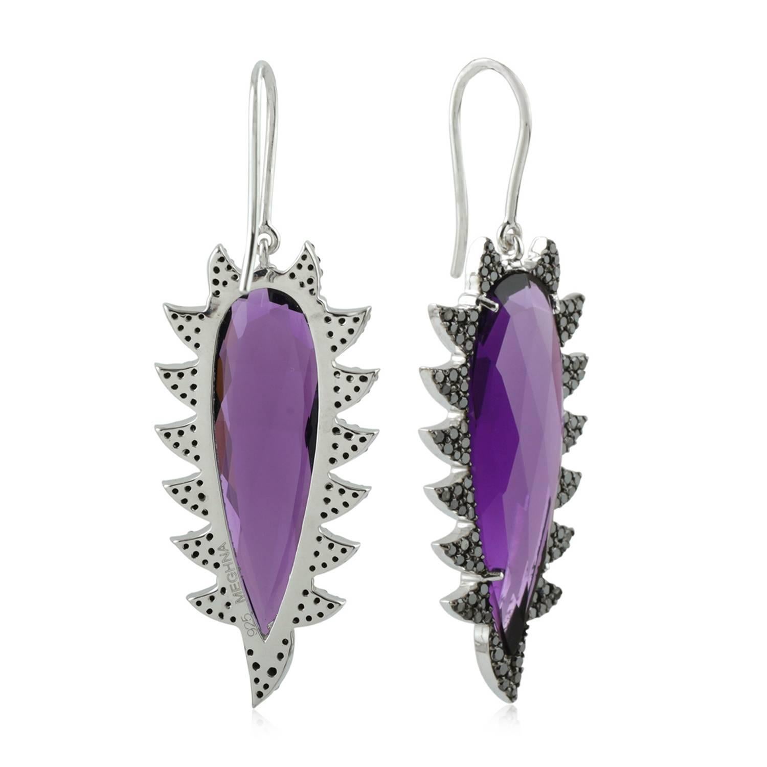 These modern, edgy and fiercely gorgeous drop earrings are handcrafted in 14K gold, sterling silver, 19.14 carat amethyst and 1.24 carat of black diamonds. Exquisitely framed in signature 