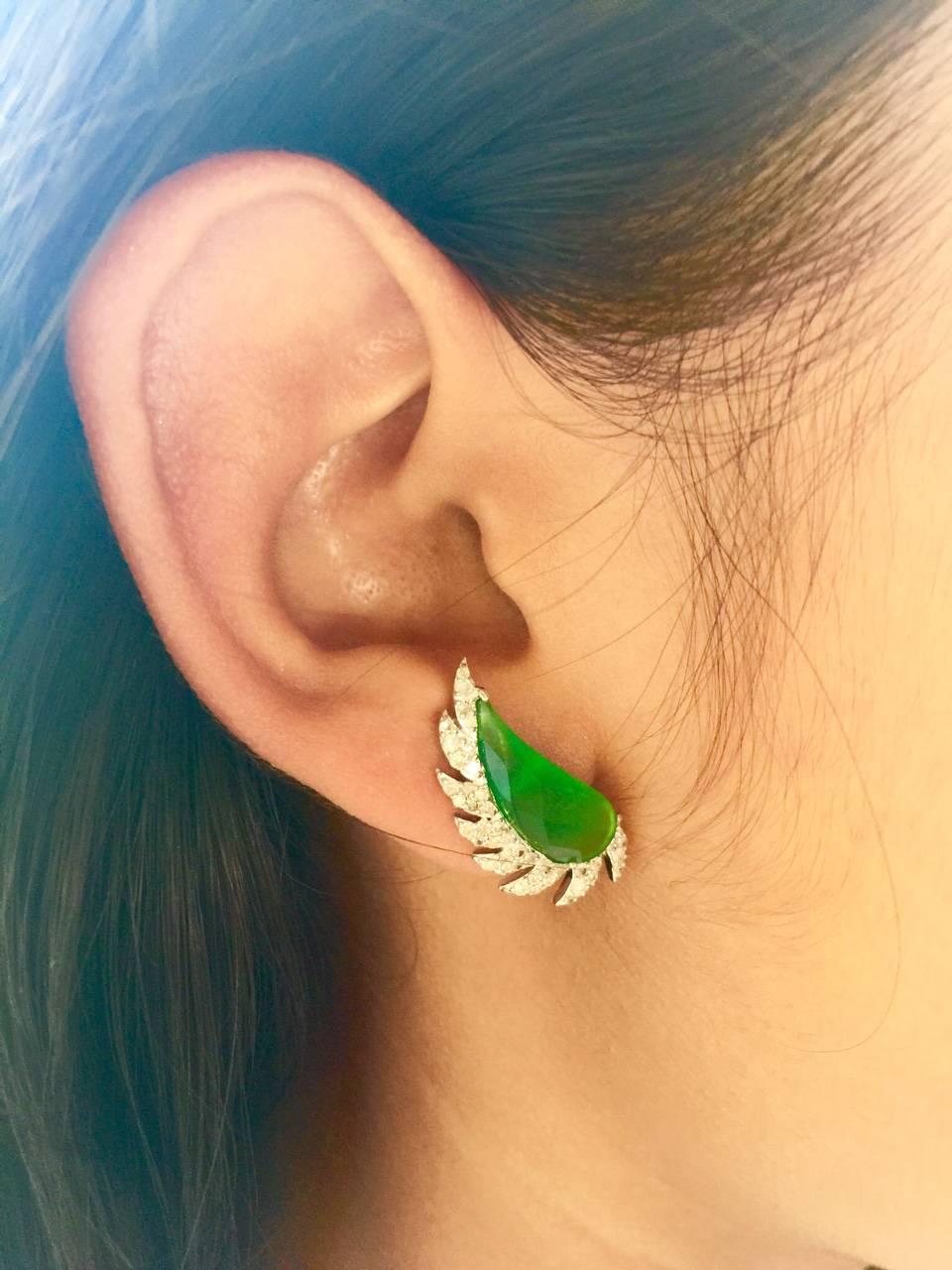 These distinctive stud earrings are modern twist to fine jewelry, handcrafted in 14K gold, sterling silver, green chalcedony and diamonds. The iridescent 16.0-ct rose cut green chalcedony is surrounded by 0.67-ct signature diamond pave arches. A