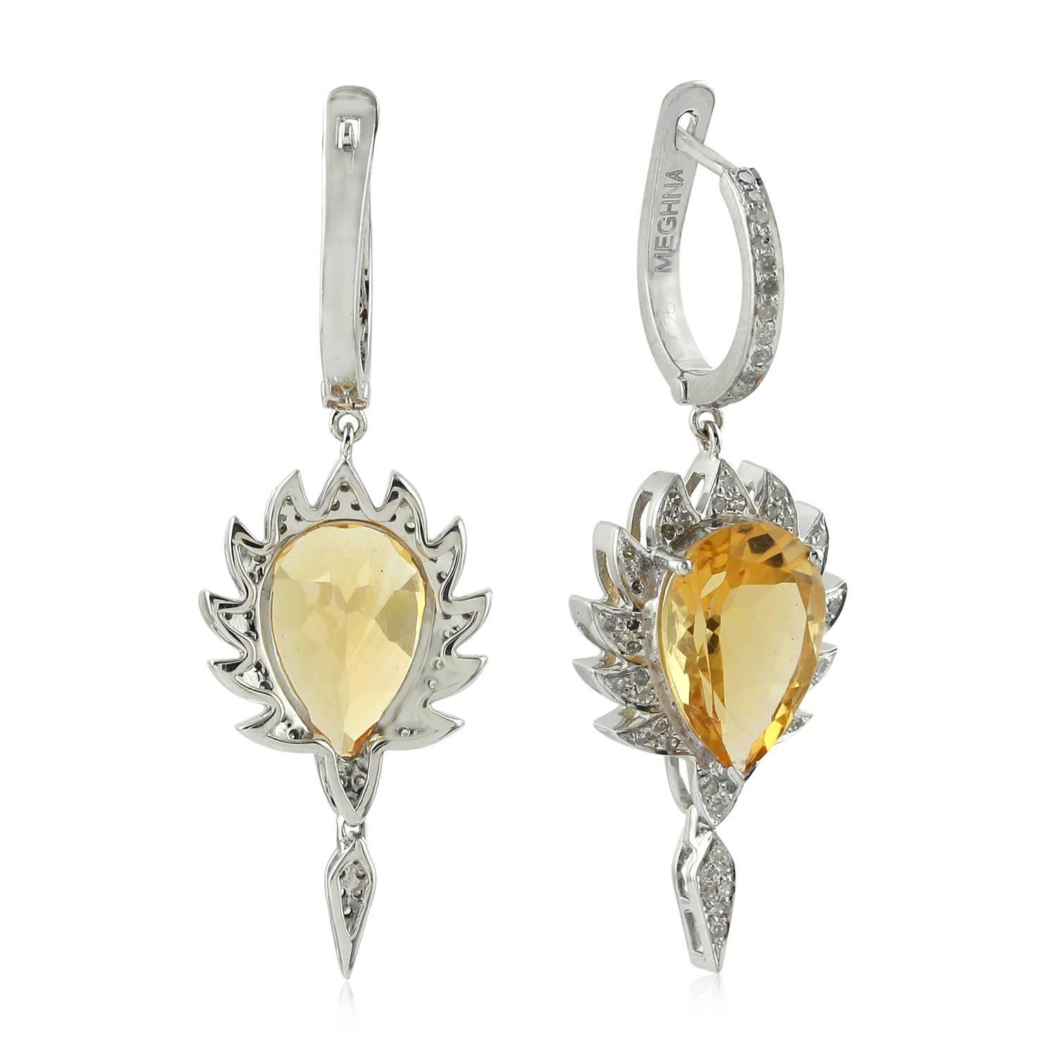 These claw drop earrings are cast in 18K gold and sterling silver. It is hand set in 9.15 carat citrine and .55 carat of sparkling diamonds. Framed in signature 