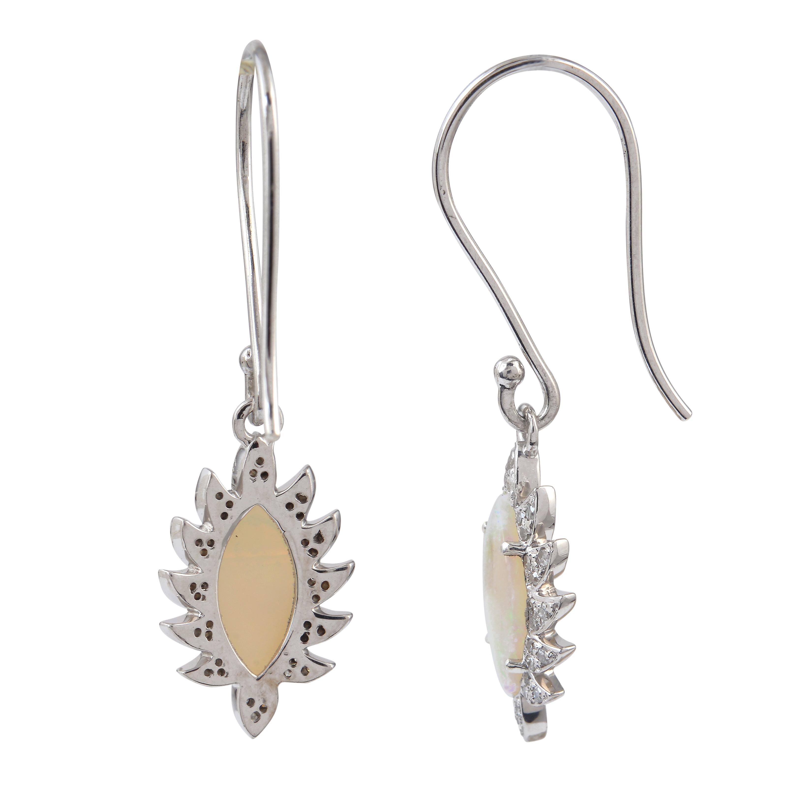 Cast in 18k gold and sterling silver. These beautiful marquise earrings are handset in 4.80 carat opal and .60 carat of sparkling diamonds. Exquisitely framed in signature 