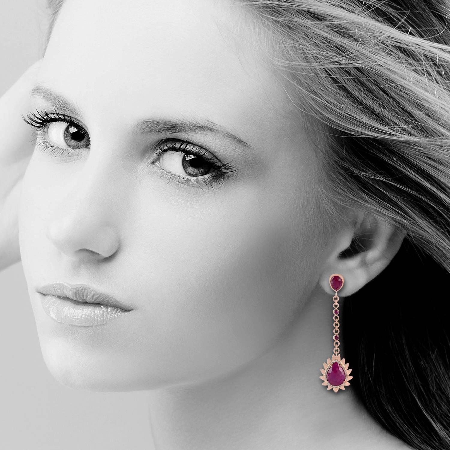 Cast in 18k gold and sterling silver.  These beautiful flame earrings are handset in 11.92 carat ruby and .32 carat of sparkling diamonds. Exquisitely framed in signature 