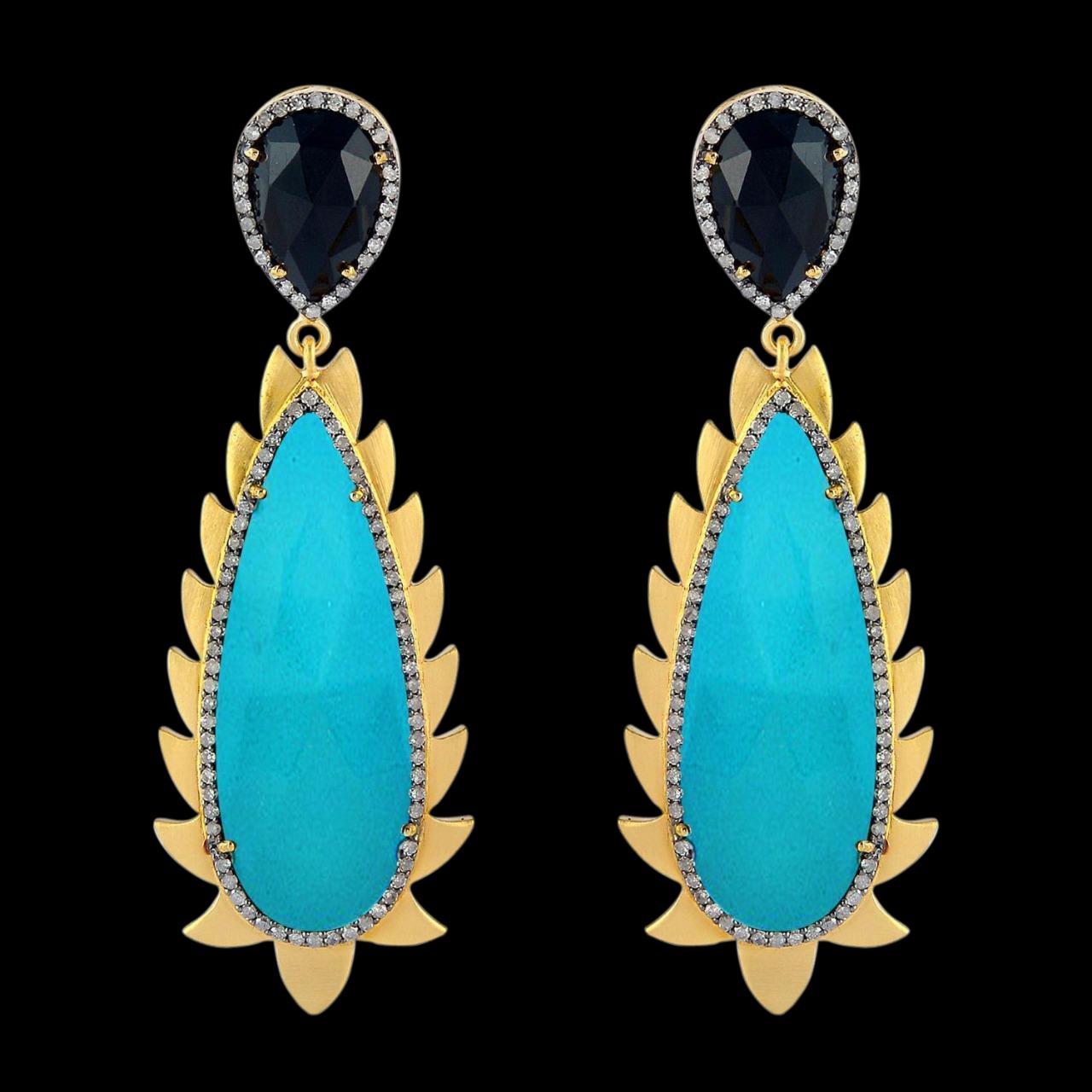 These modern and fiercely gorgeous drop earrings are handcrafted in 14K gold, sterling silver, 33.0 carat Turquoise, 6.20 carat Black Onyx and 1.32 carat of sparkling diamonds . Exquisitely framed in signature 