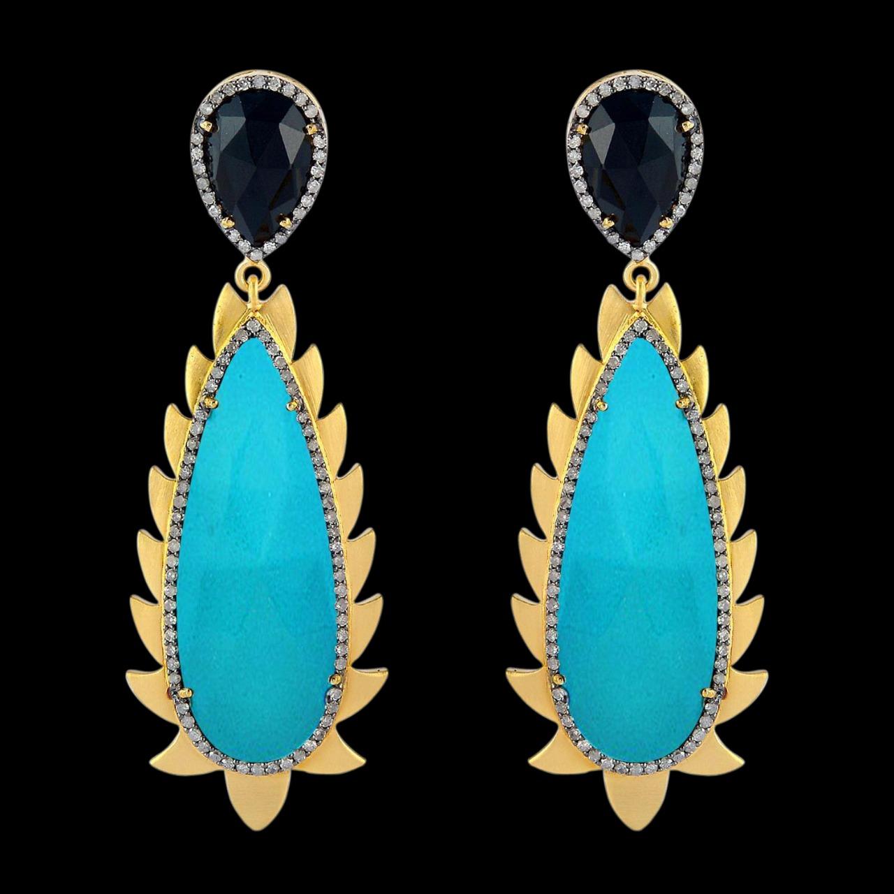 These modern and fiercely gorgeous drop earrings are handcrafted in 14K gold, sterling silver, 33.0 carat Turquoise, 6.20 carat Black Onyx and 1.32 carat of sparkling diamonds . Exquisitely framed in signature 